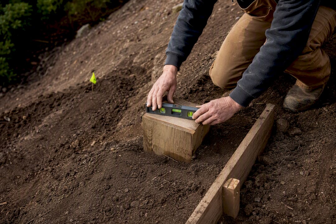 Checking grade beside stair landing footing