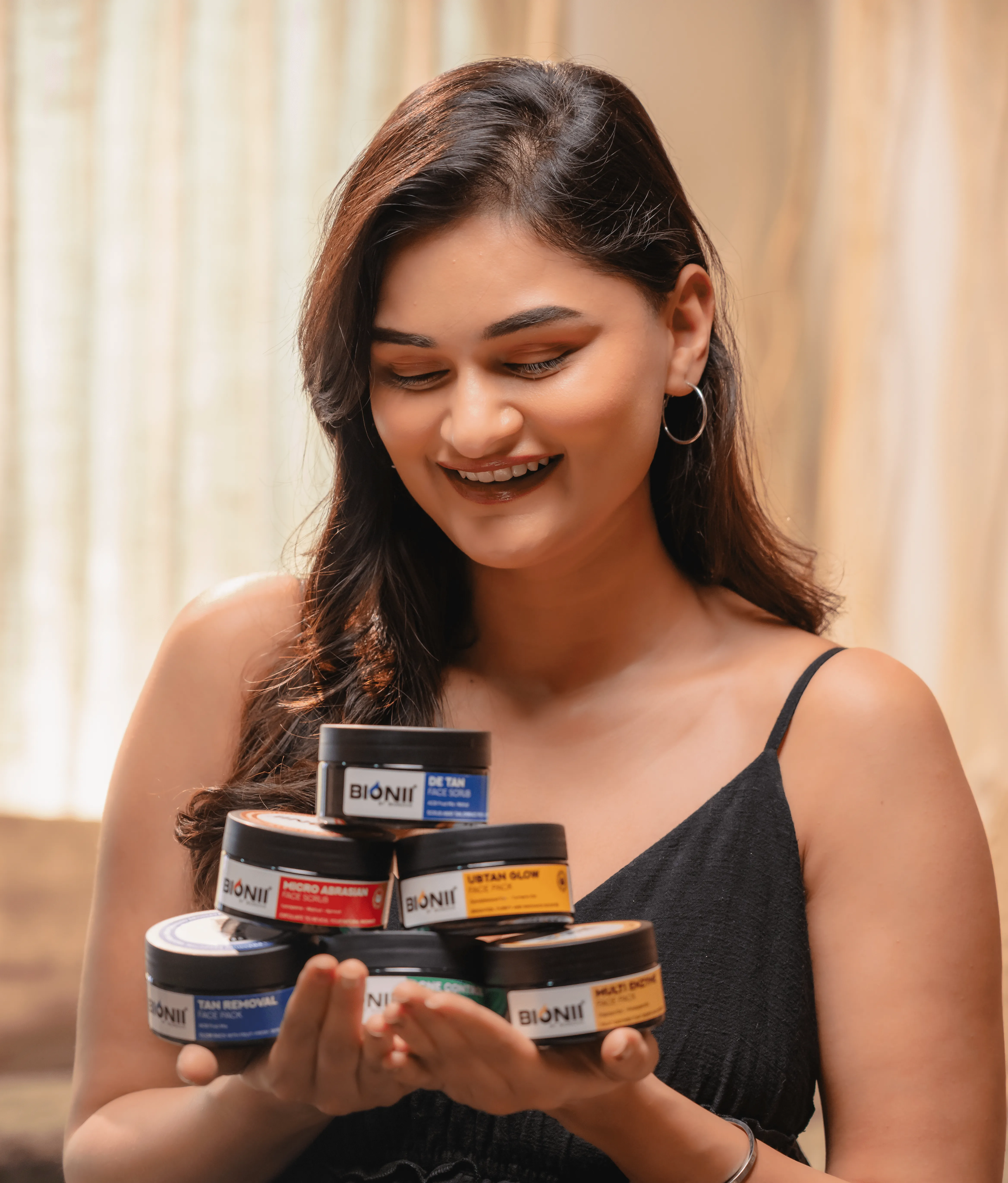 Close-up of woman holding Bionii wellness product indoors
