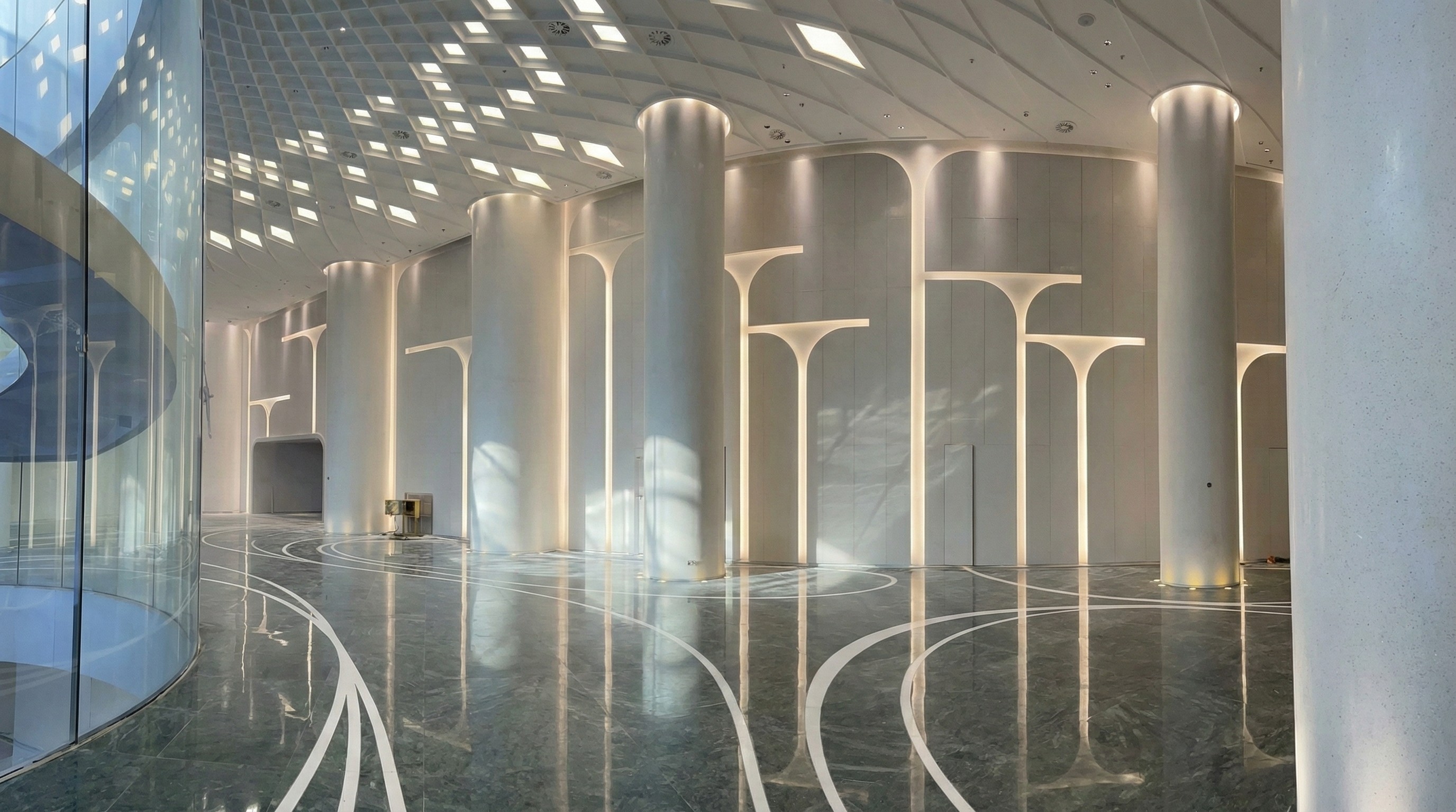 Grand subway station lobby with artistic marble floor inlays and glowing architectural stone columns by NOVA STONE.