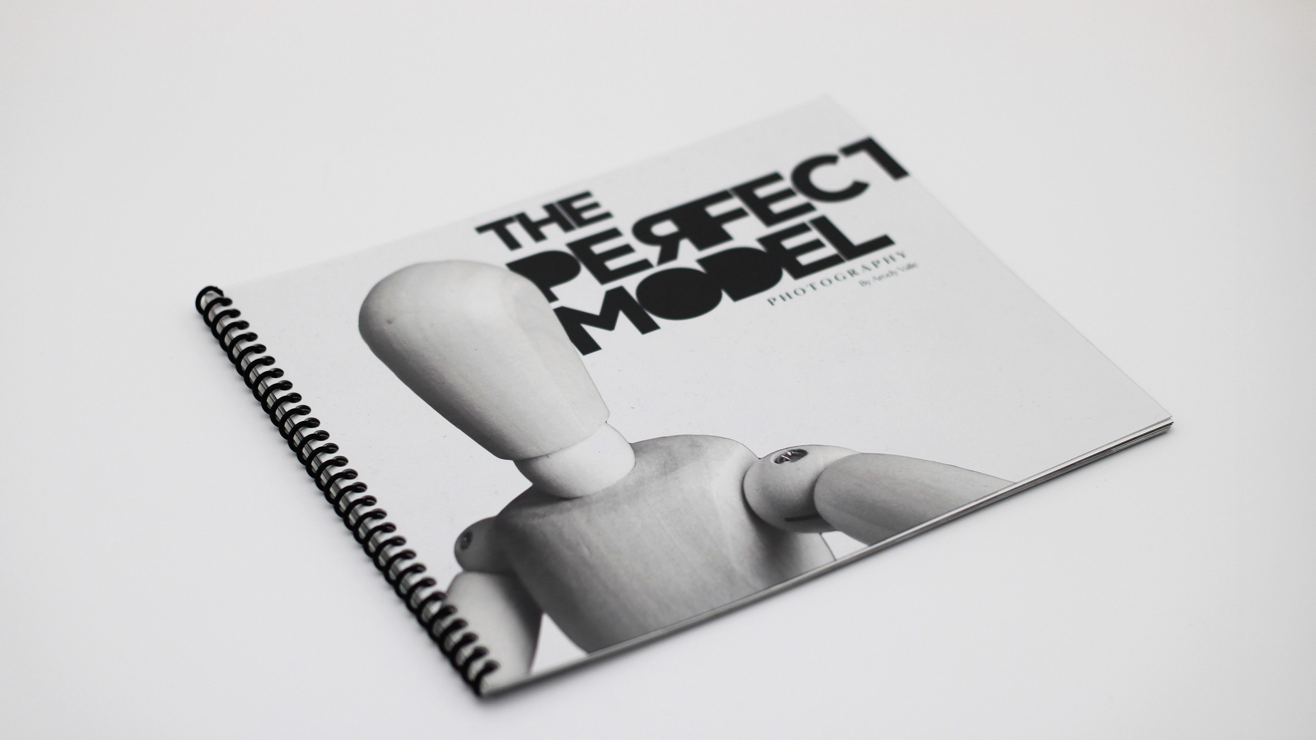 Black and white photo of a photography puclication which features a drawing mannequin as the cover model. His stance seems as if its taking a selfie. The title reads "The Perfect Model". The subtitle reads "photography" by Arody Valle