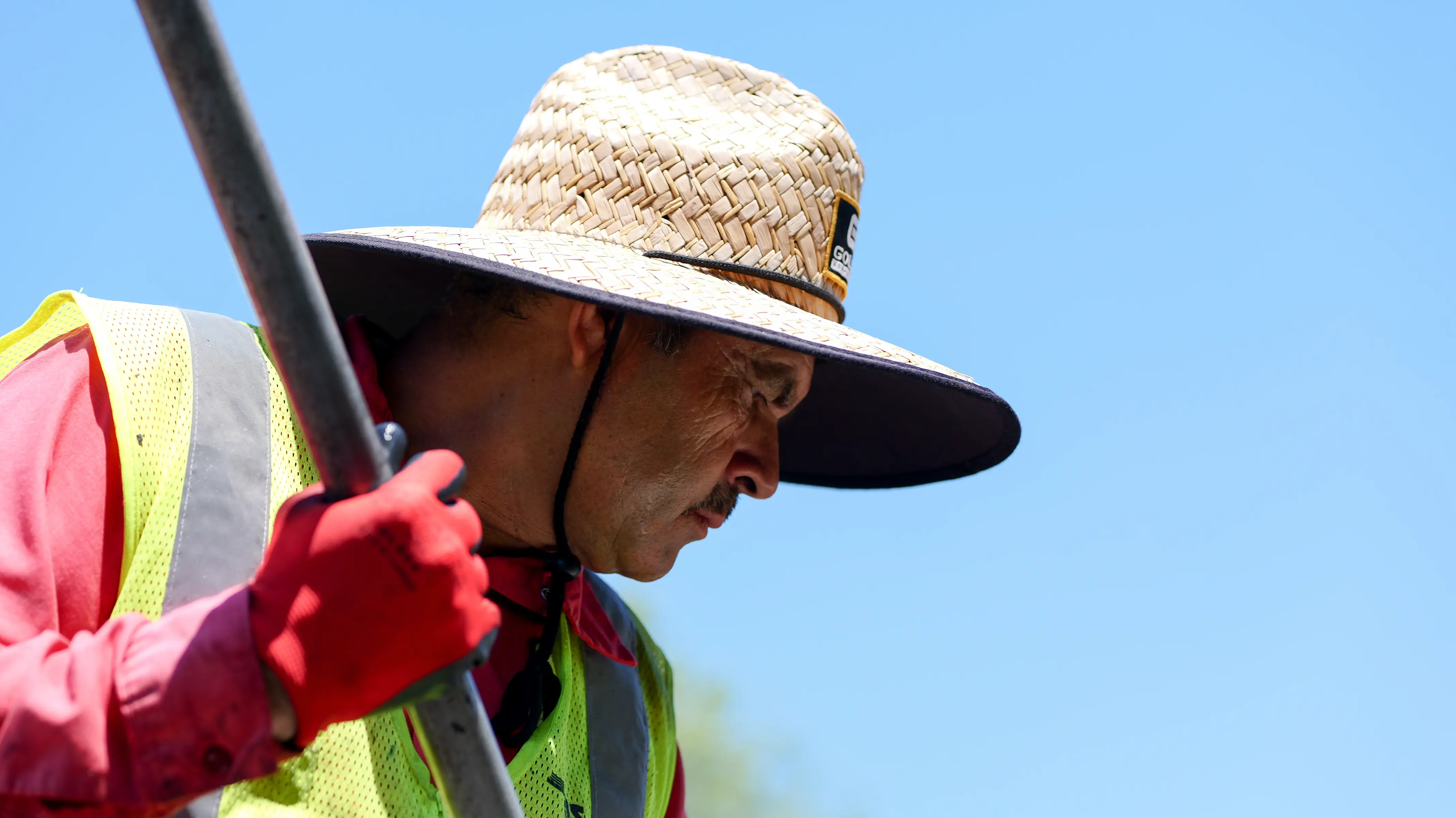 Closeup face shot of asphalt crew laborer raking pavement
