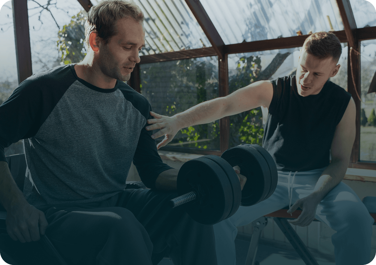 Medium shot friends training together with dumbbells