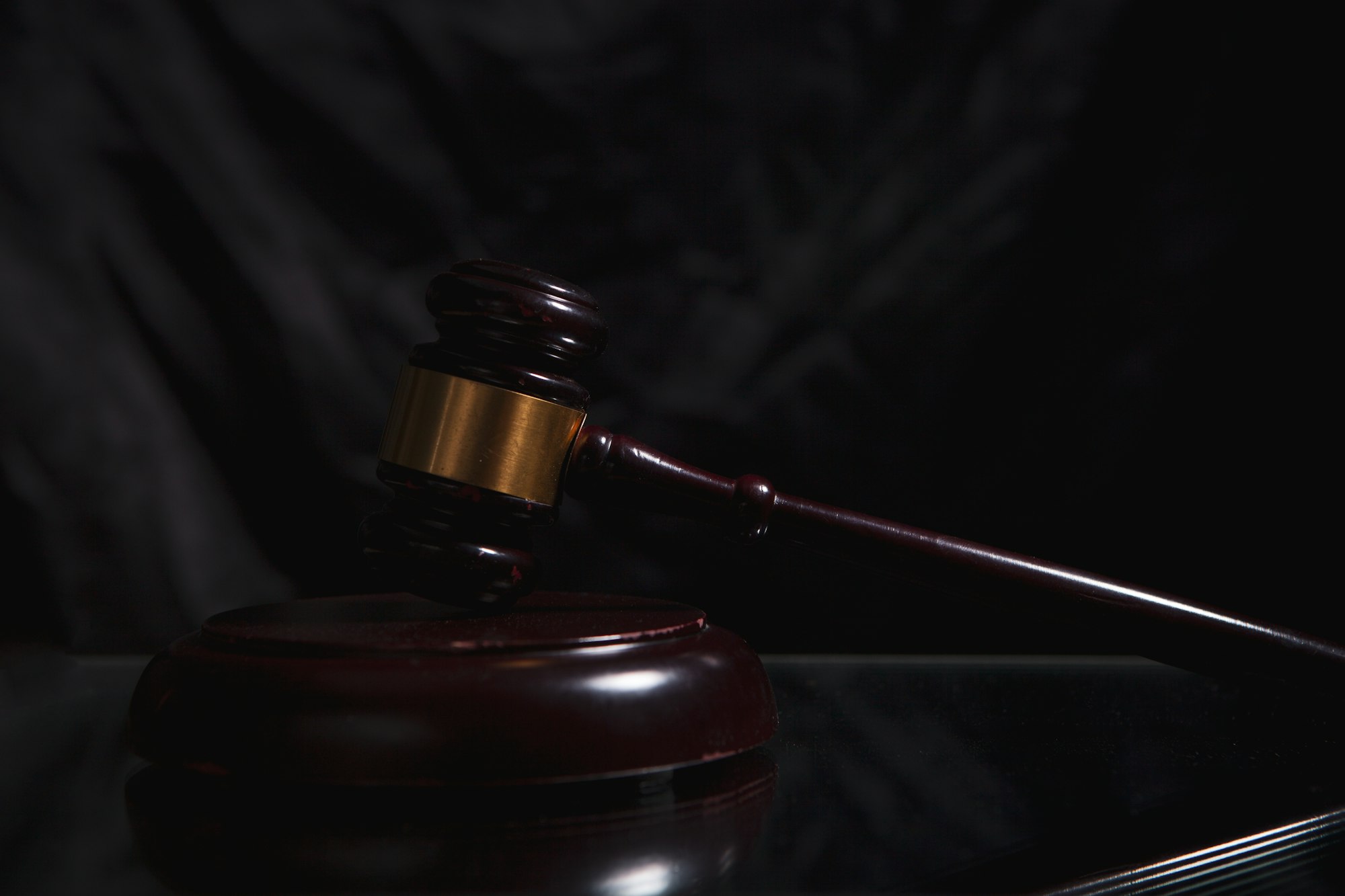 Judge's gavel on a dark wooden surface