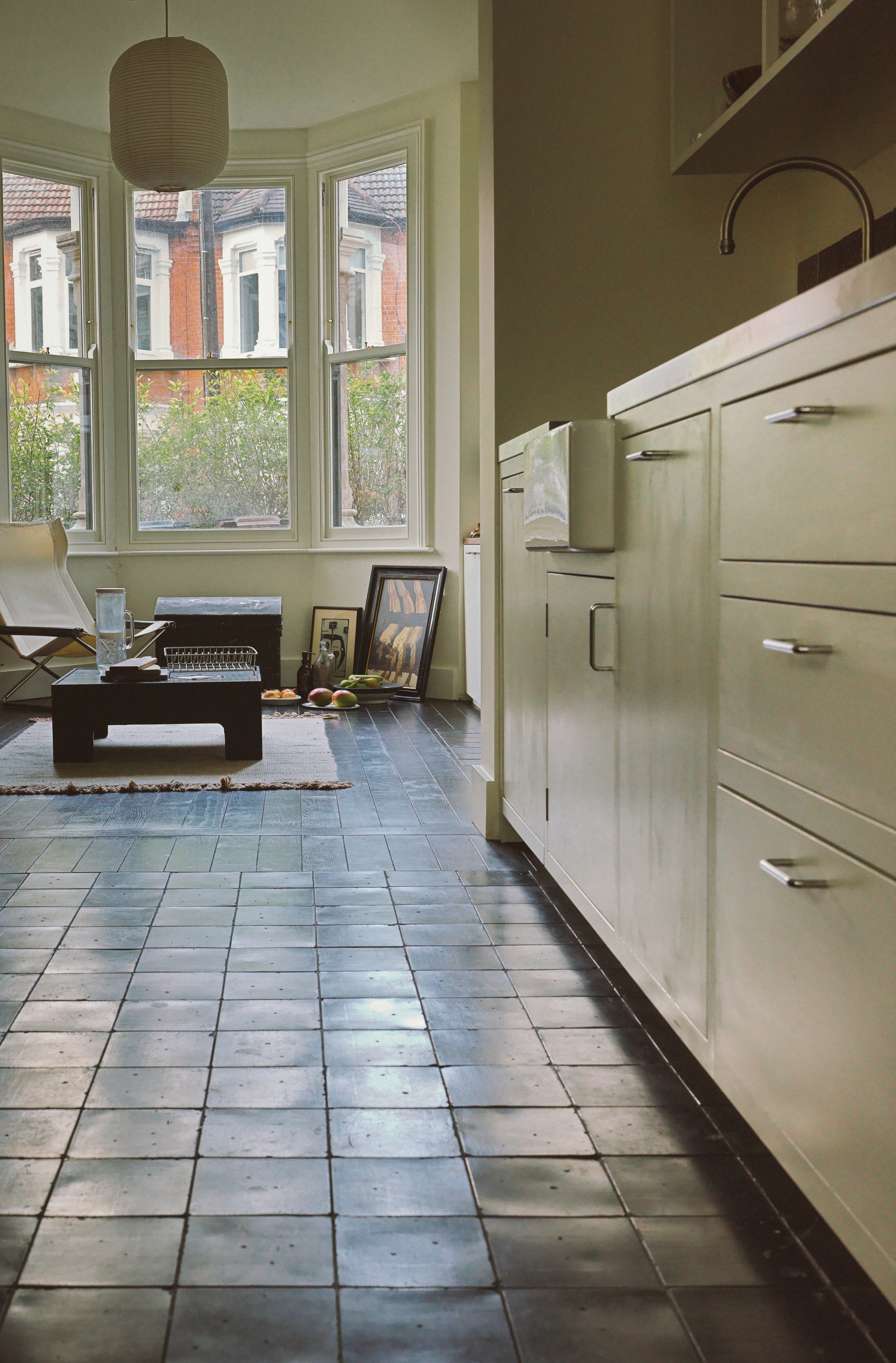 Framed kitchen view and polished volcanic tile flooring