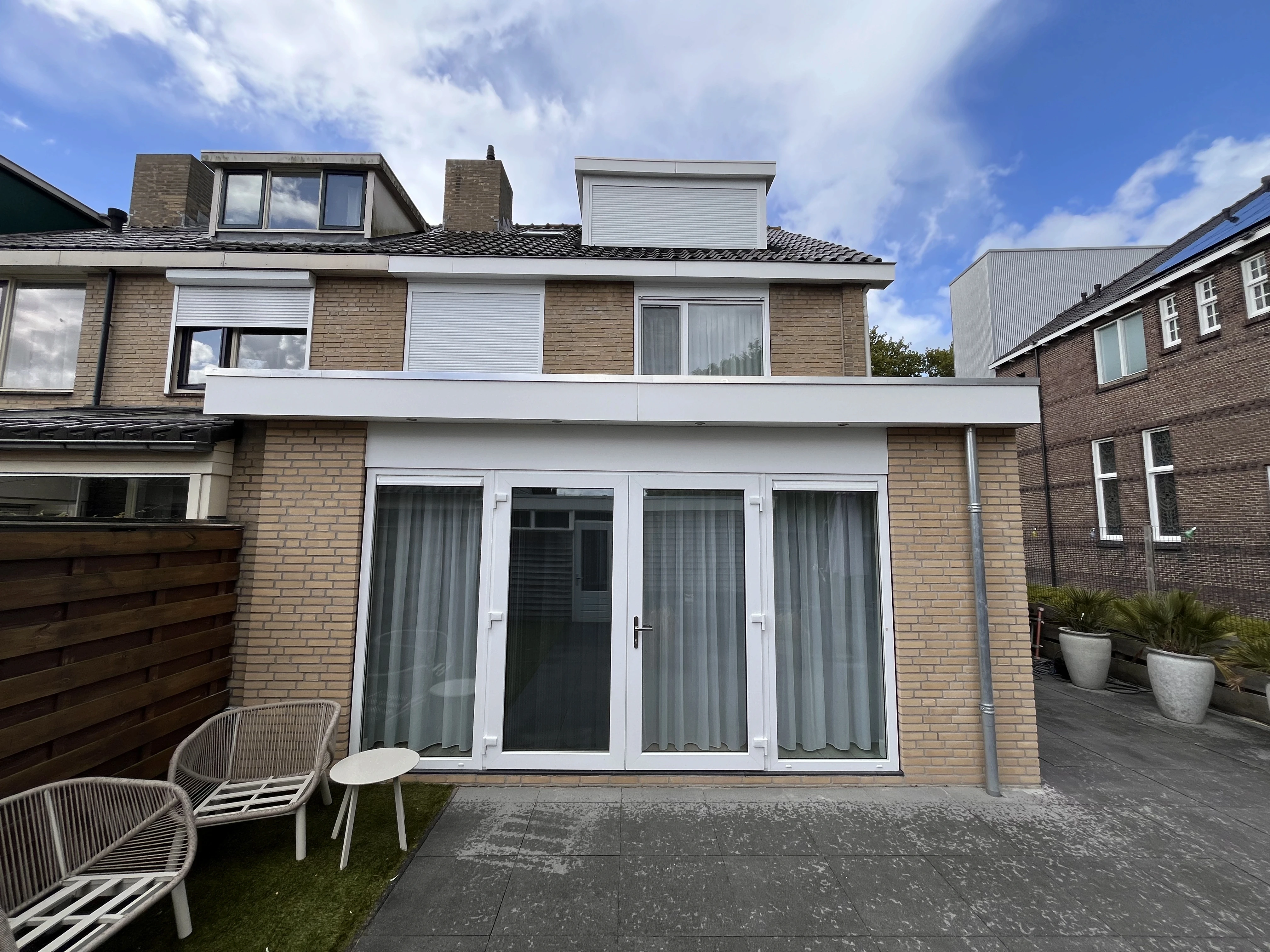 utility man standing in scissor platform cleaning glass window