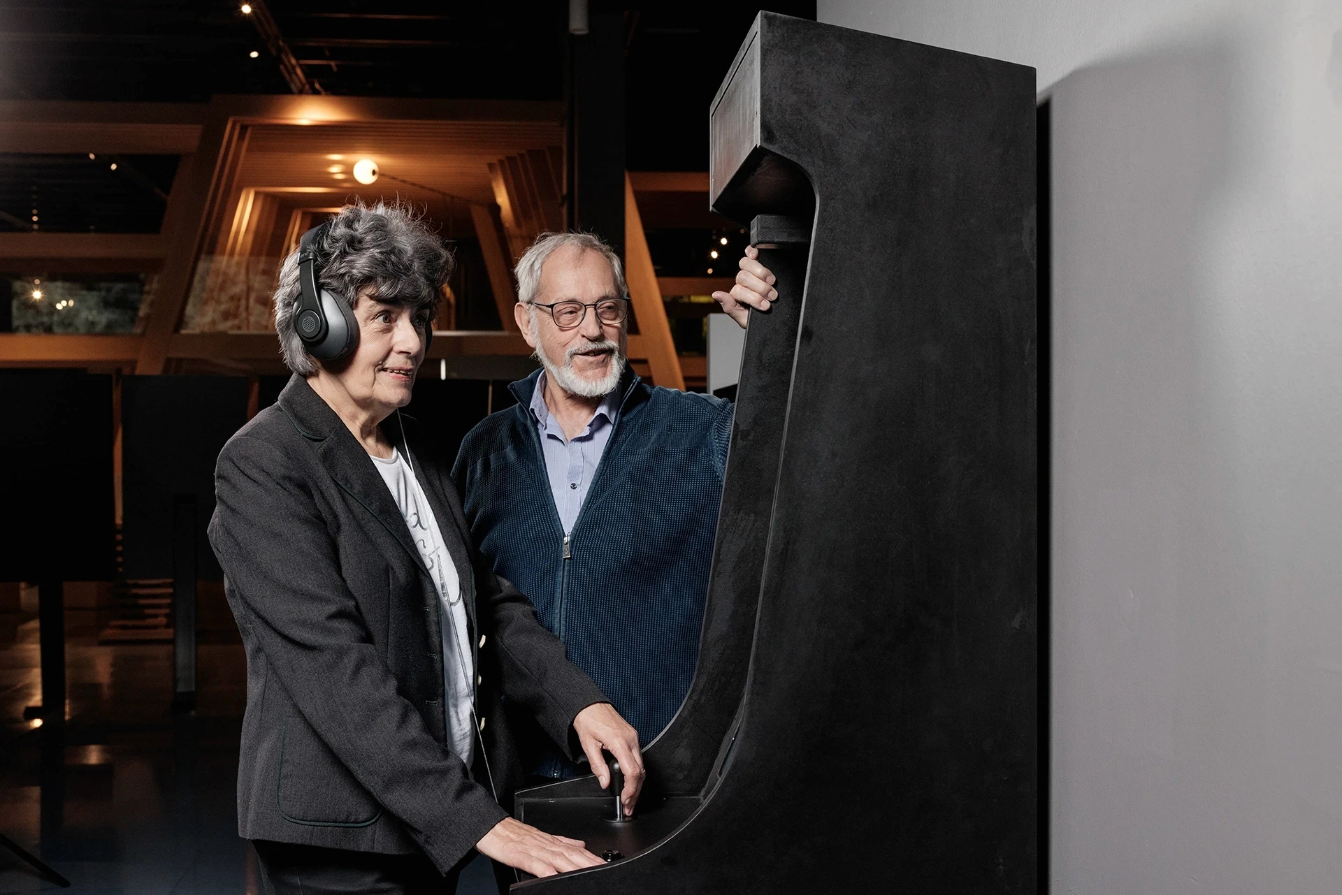 Couple interacting with an arcade game.