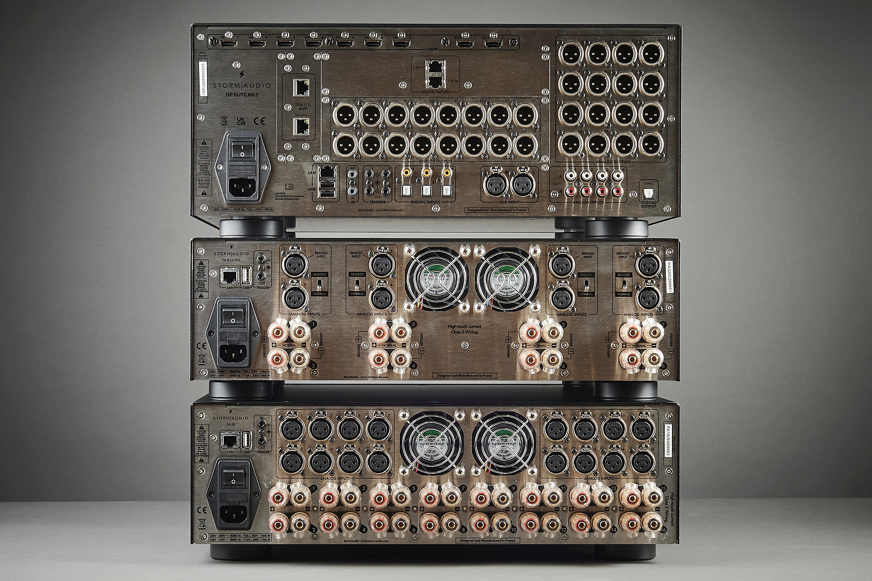 Audio equipment rear panels with numerous XLR and speaker outputs.