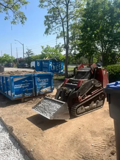 Falcons Landscaping using machinery for gravel placement during build.