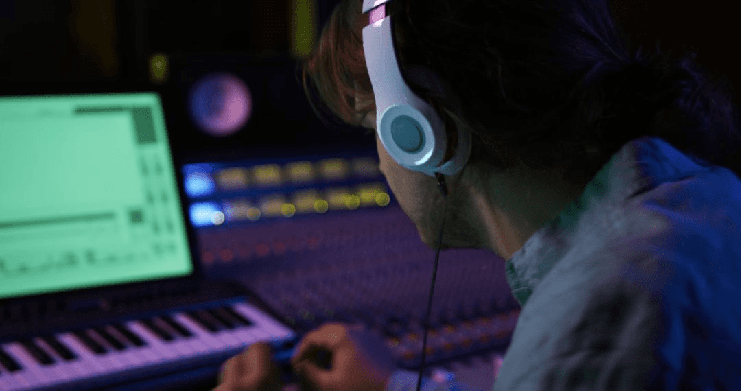 Sound engineer deeply focused on his task in a modern recording studio. Unique features such as the mixing desk and digital interface highlight music production process.