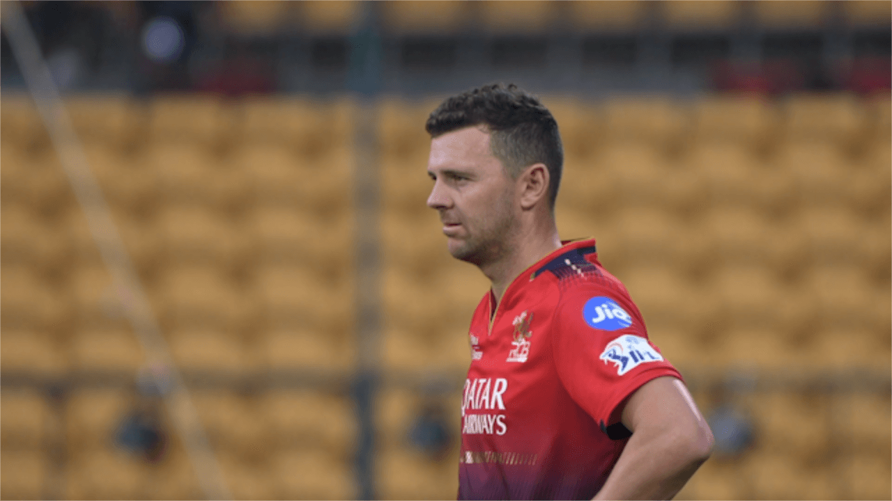 Original plate: coach in red training kit against empty stands
