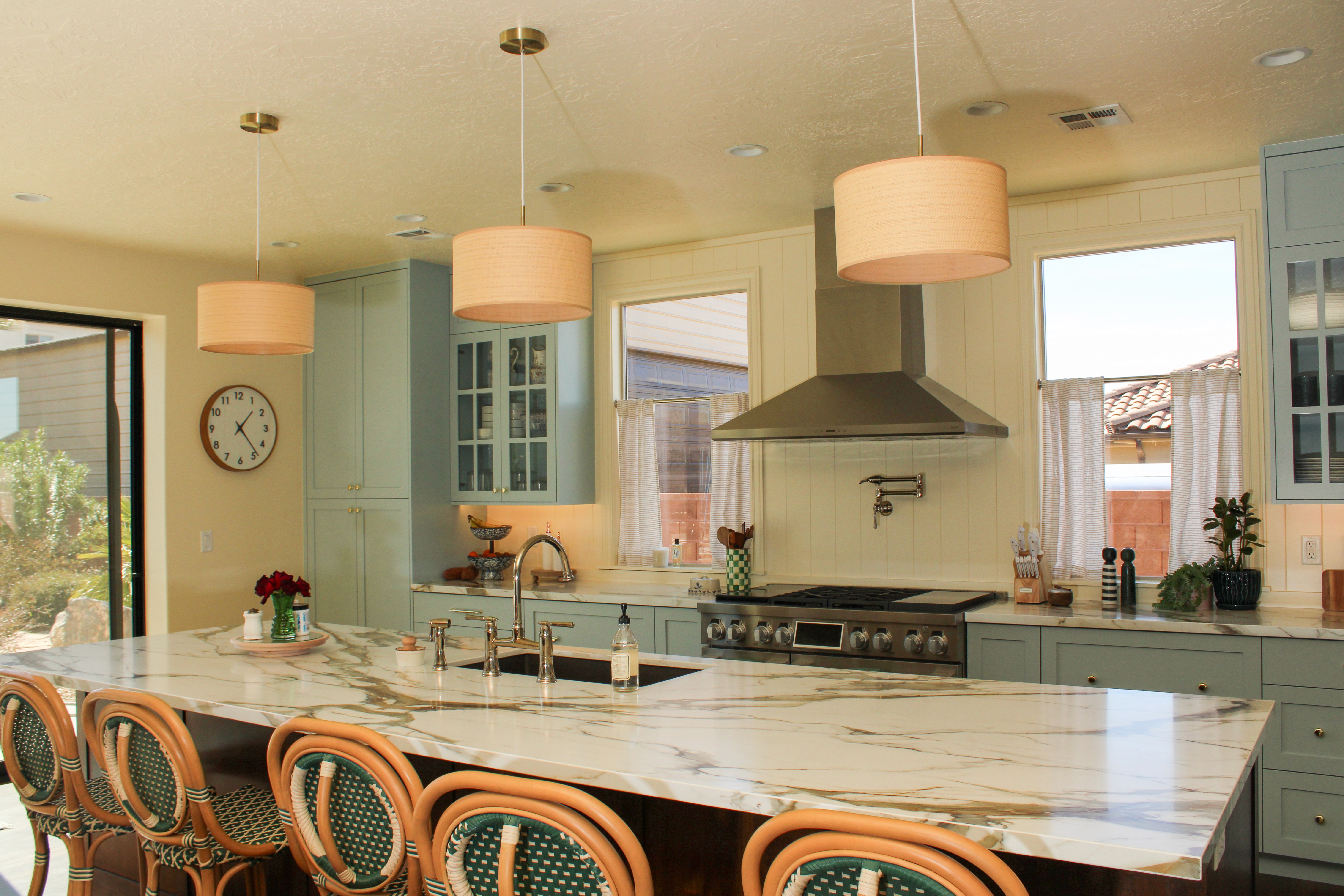 Bright, airy kitchen with pale blue cabinets and modern appliances in a Washington, Utah home