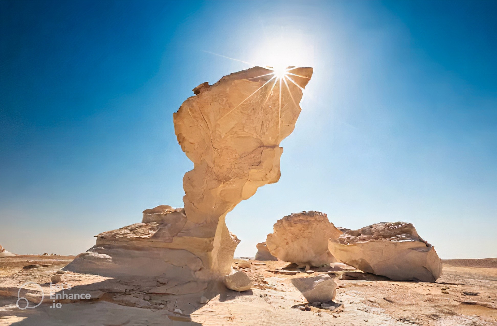 A large rock formation in the middle of a desert