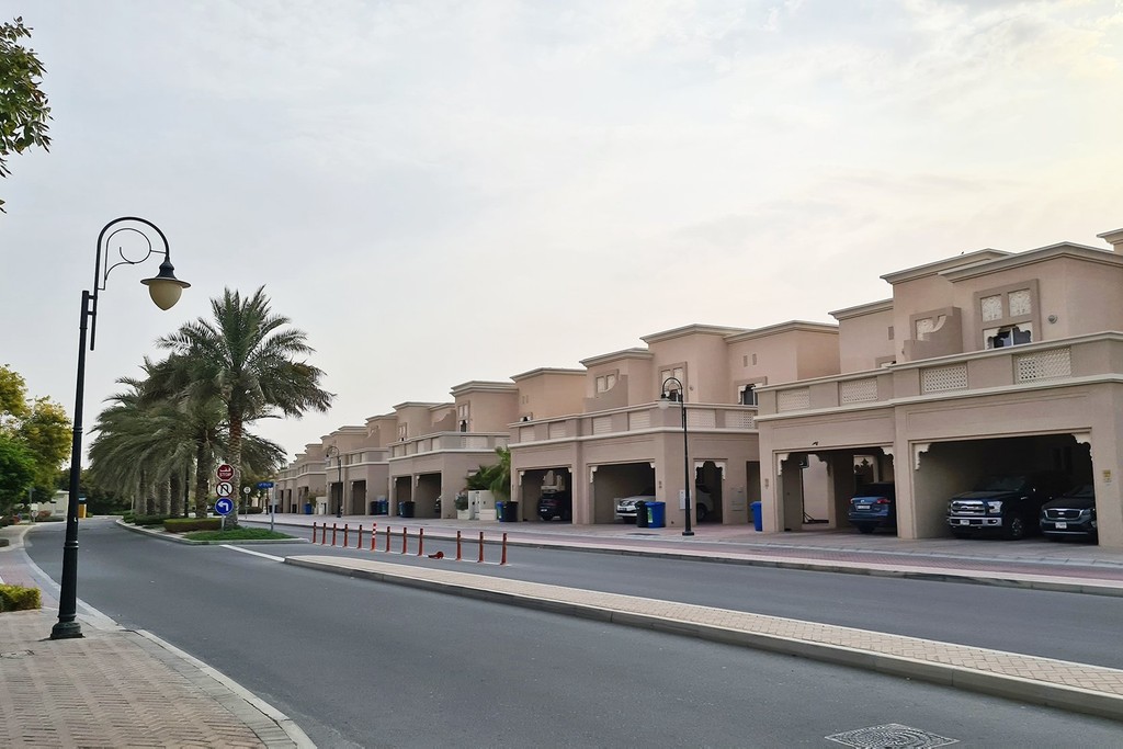 Cedre Villas in Dubai Silicon Oasis: residential street with houses and parked cars.