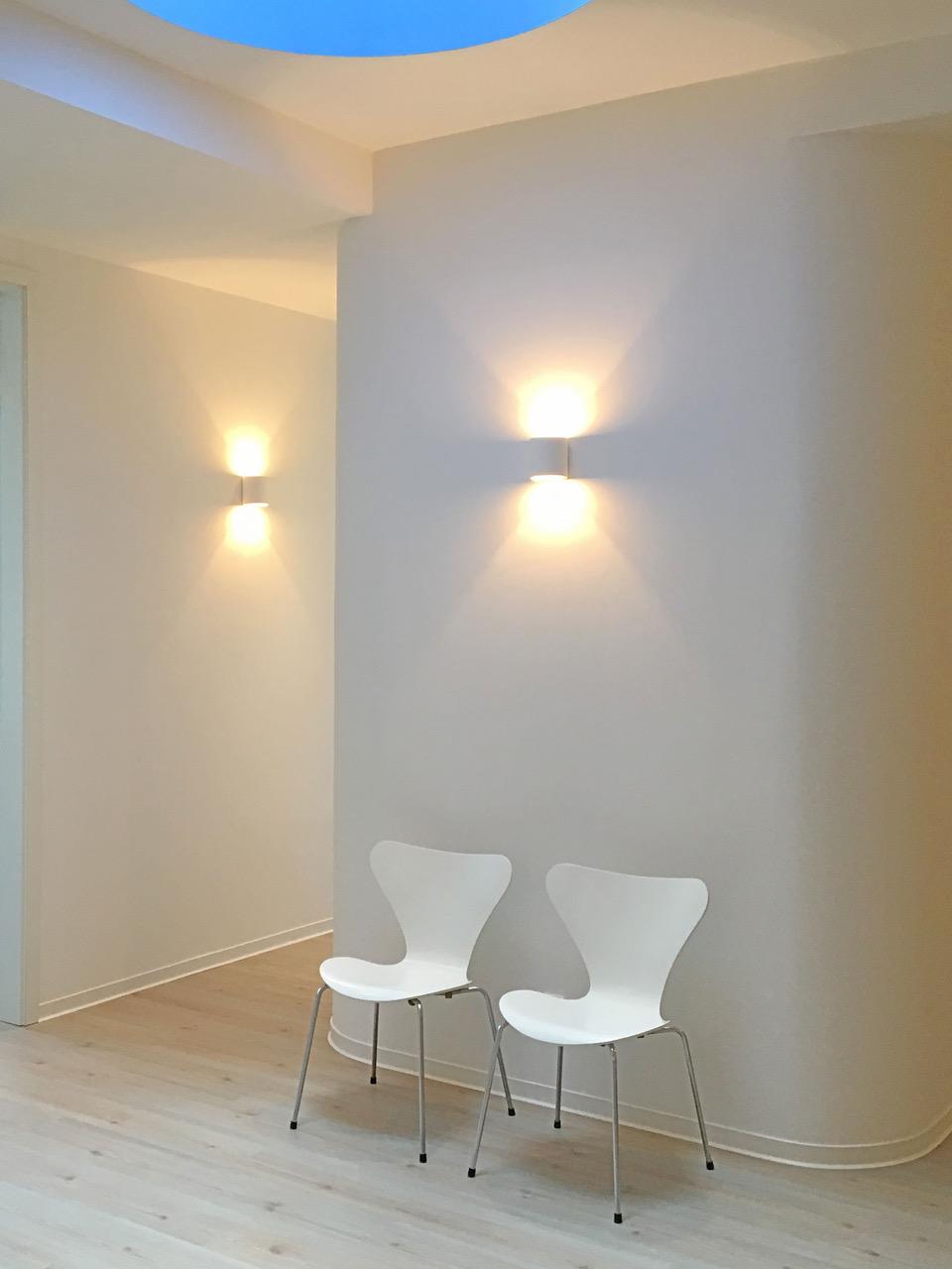 a pregnant woman laying on a bed covered in a blanket