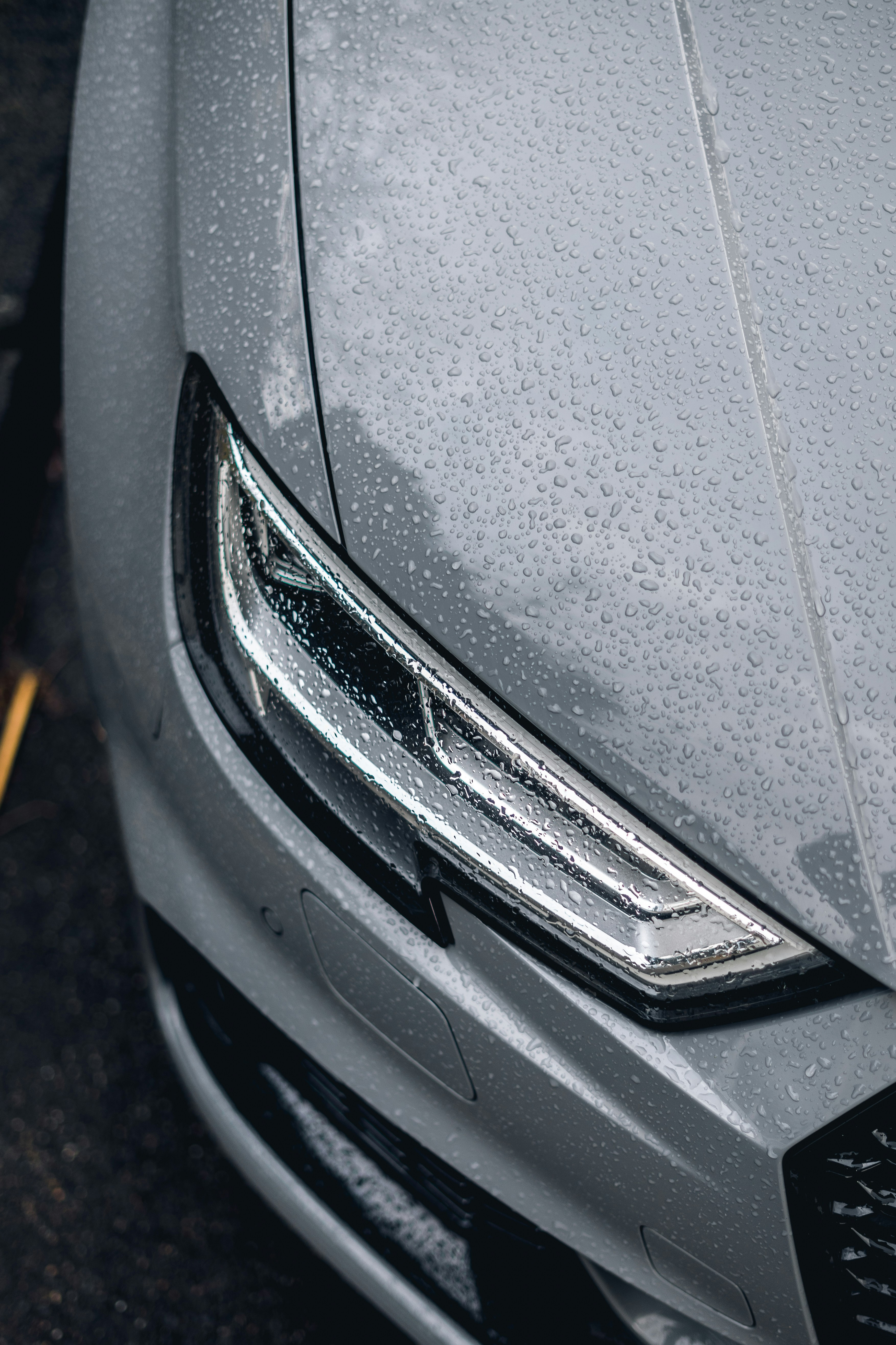 a close up of the front of a silver car