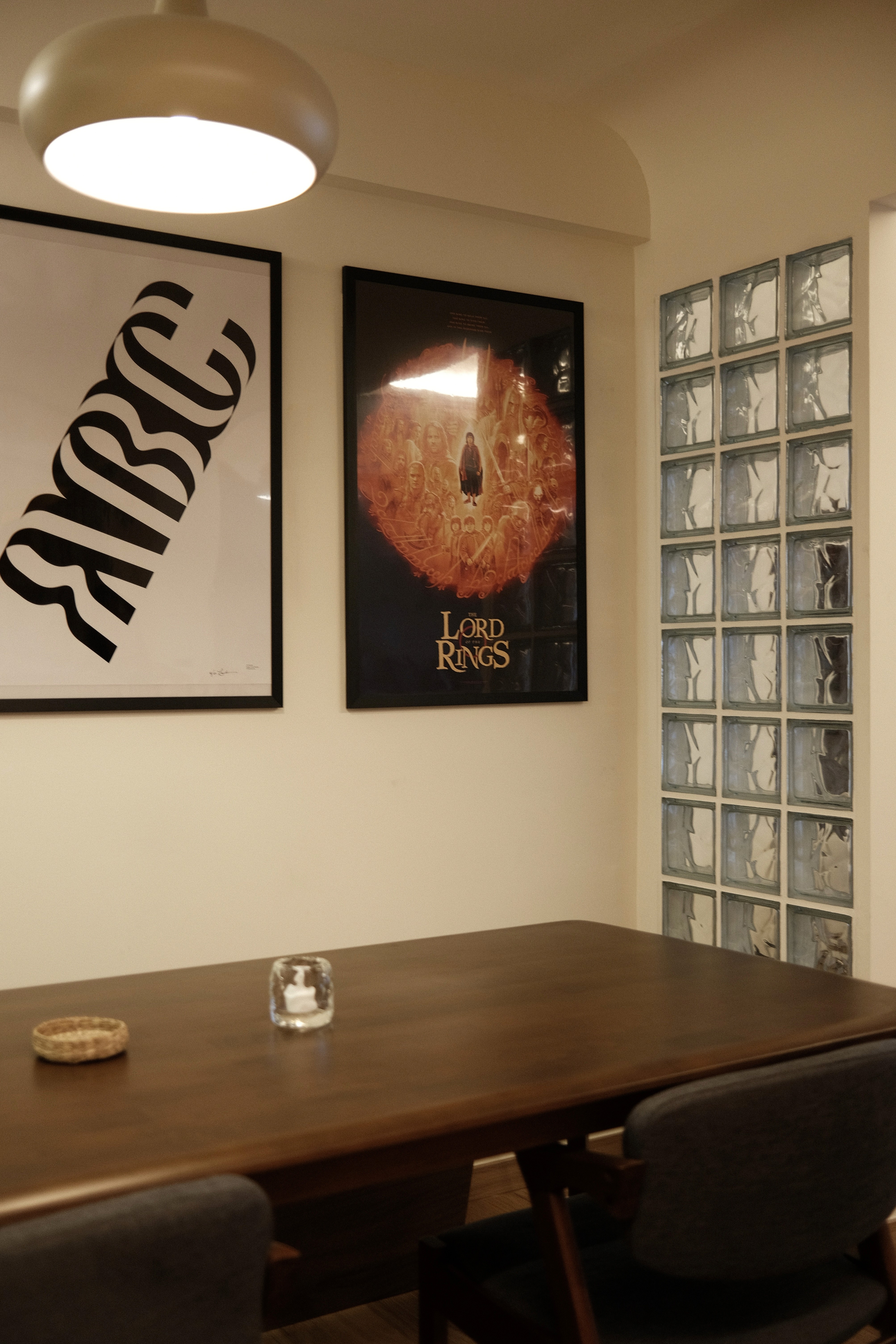 A warm, intimate gathering space where soft lighting, natural timber surfaces, and curated artwork create a relaxed setting for conversation and collaboration.