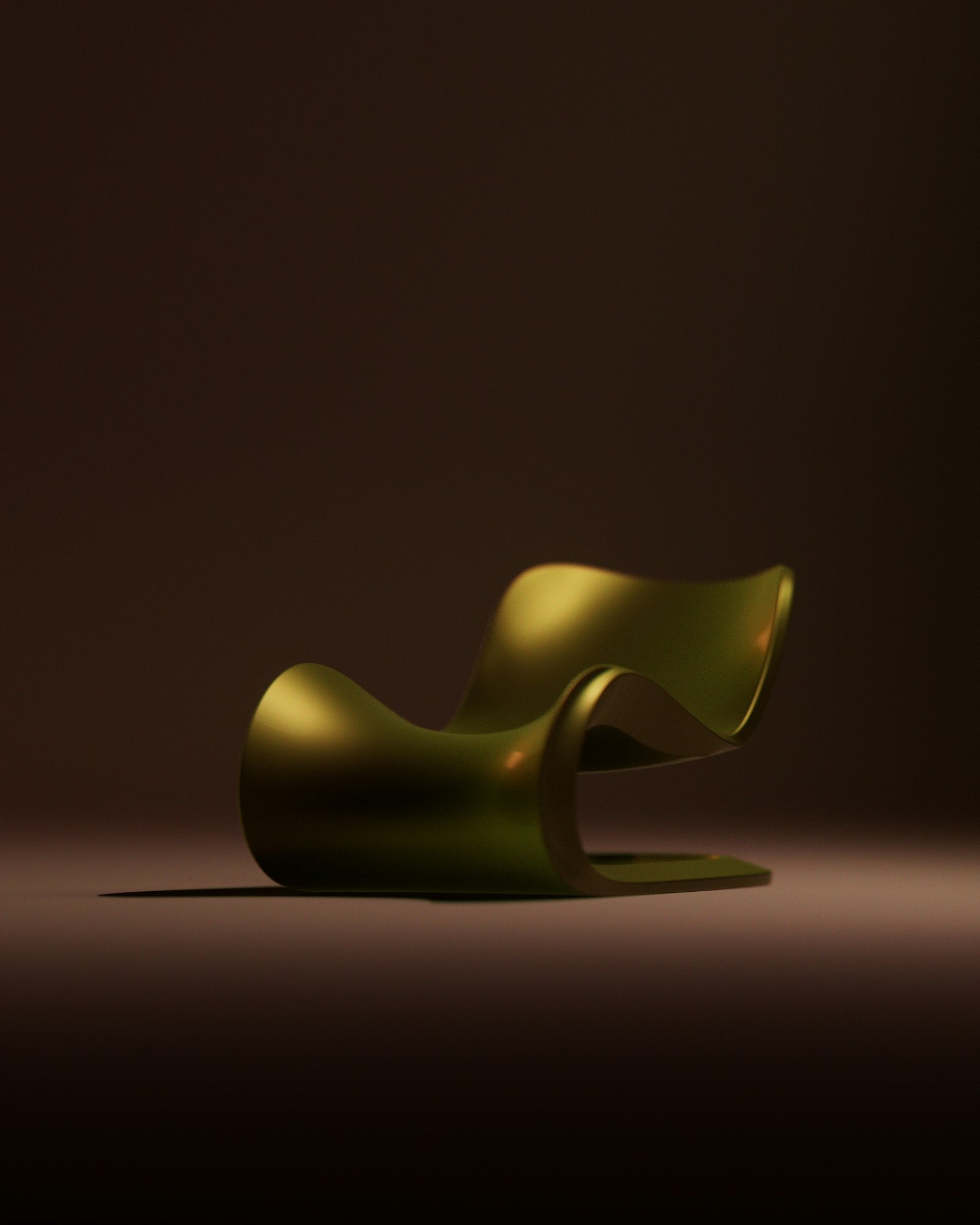 A sculptural olive lounge chair in a dark studio