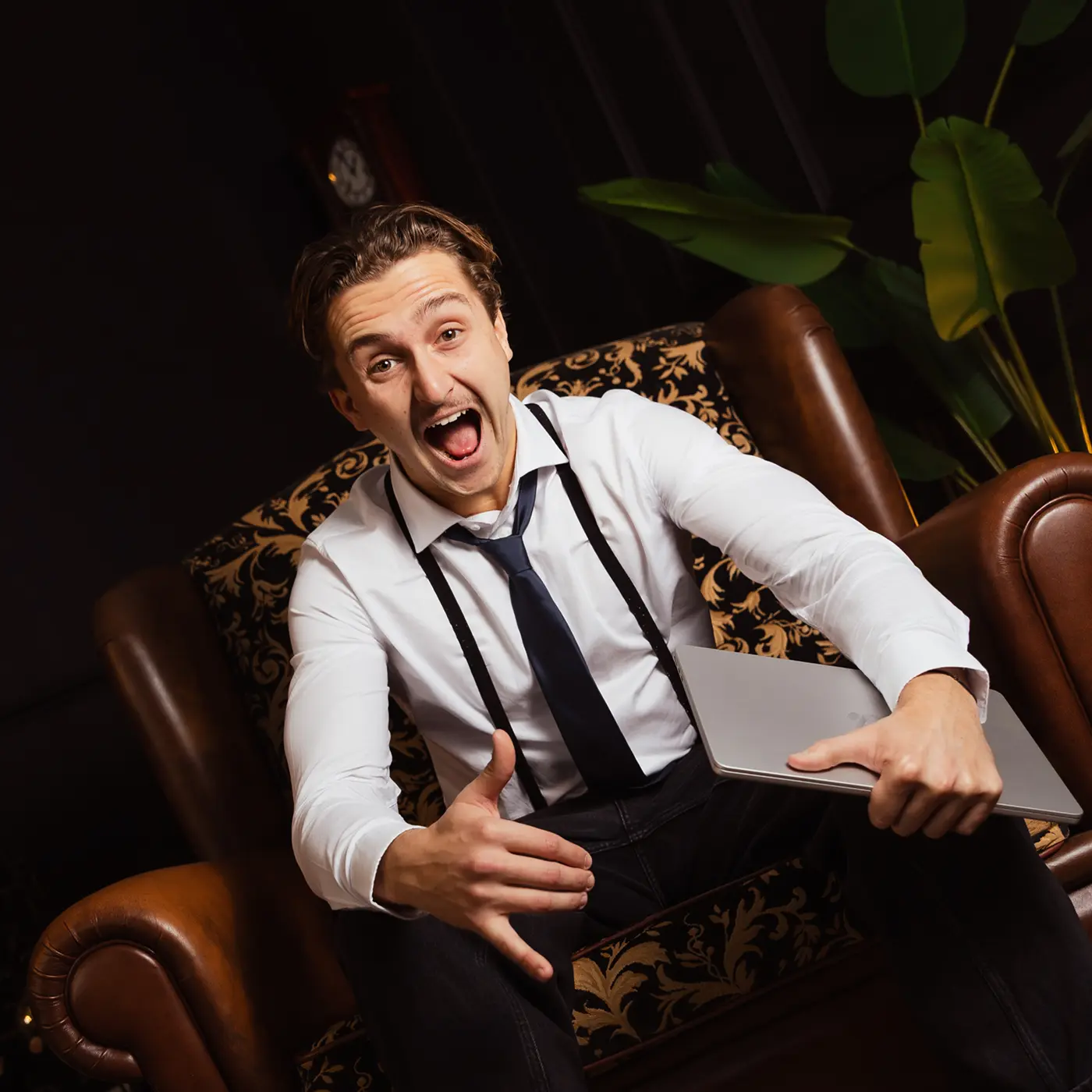 A red hot air balloon glows at sunset over mountains.