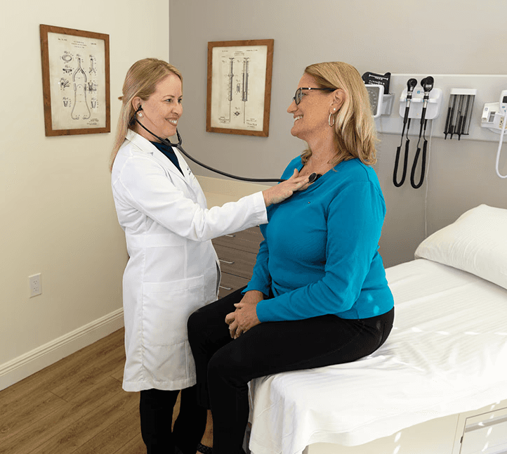 Dr. Migdalia Merida conducting a primary care exam with a Harper Health member.
