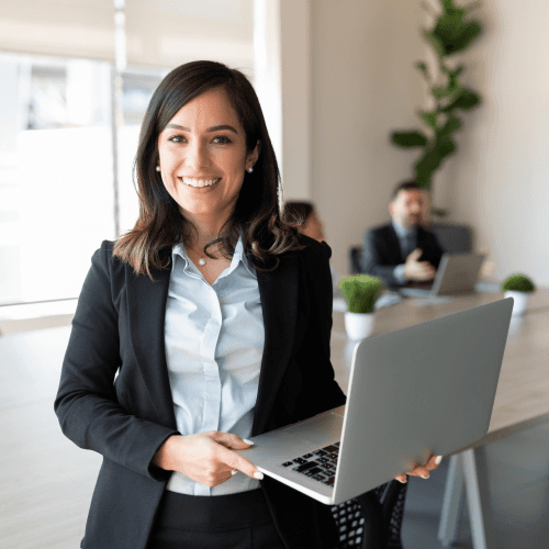 woman in blue tank top standing beside white wall