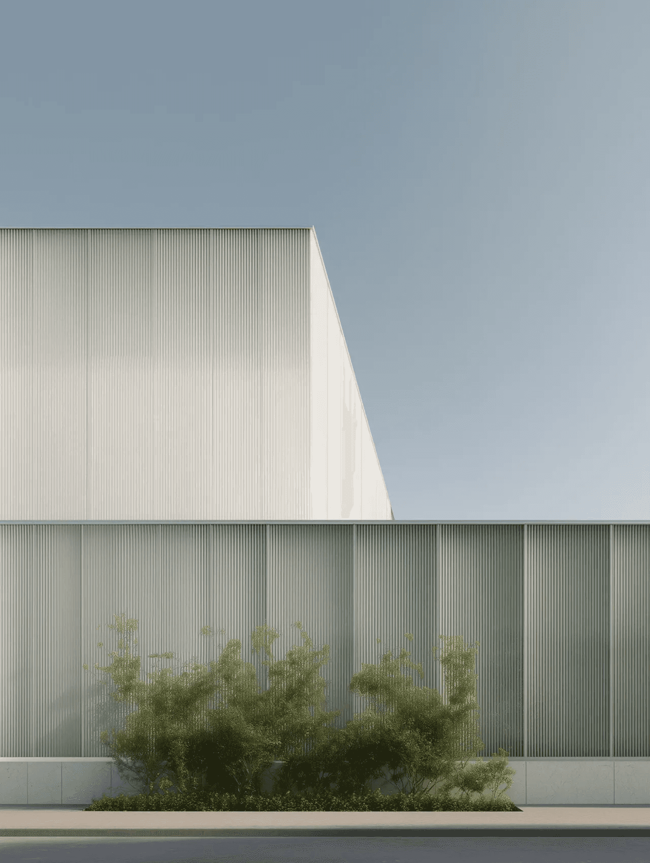 Modern minimalist building facade with vertical glass panels and clear sky