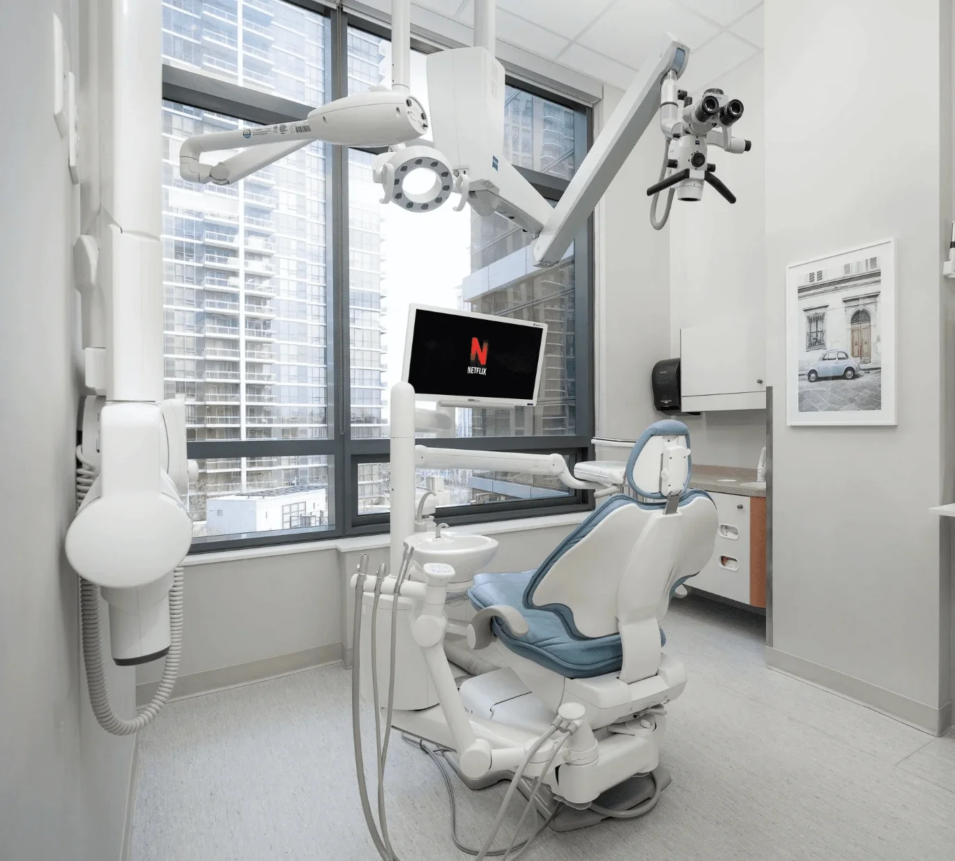 Treatment area with dental chair and dental microscope and entertainment system at at Sovrle Dental Clinic in North York, Ontario: the best dentist in North York, Ontario
