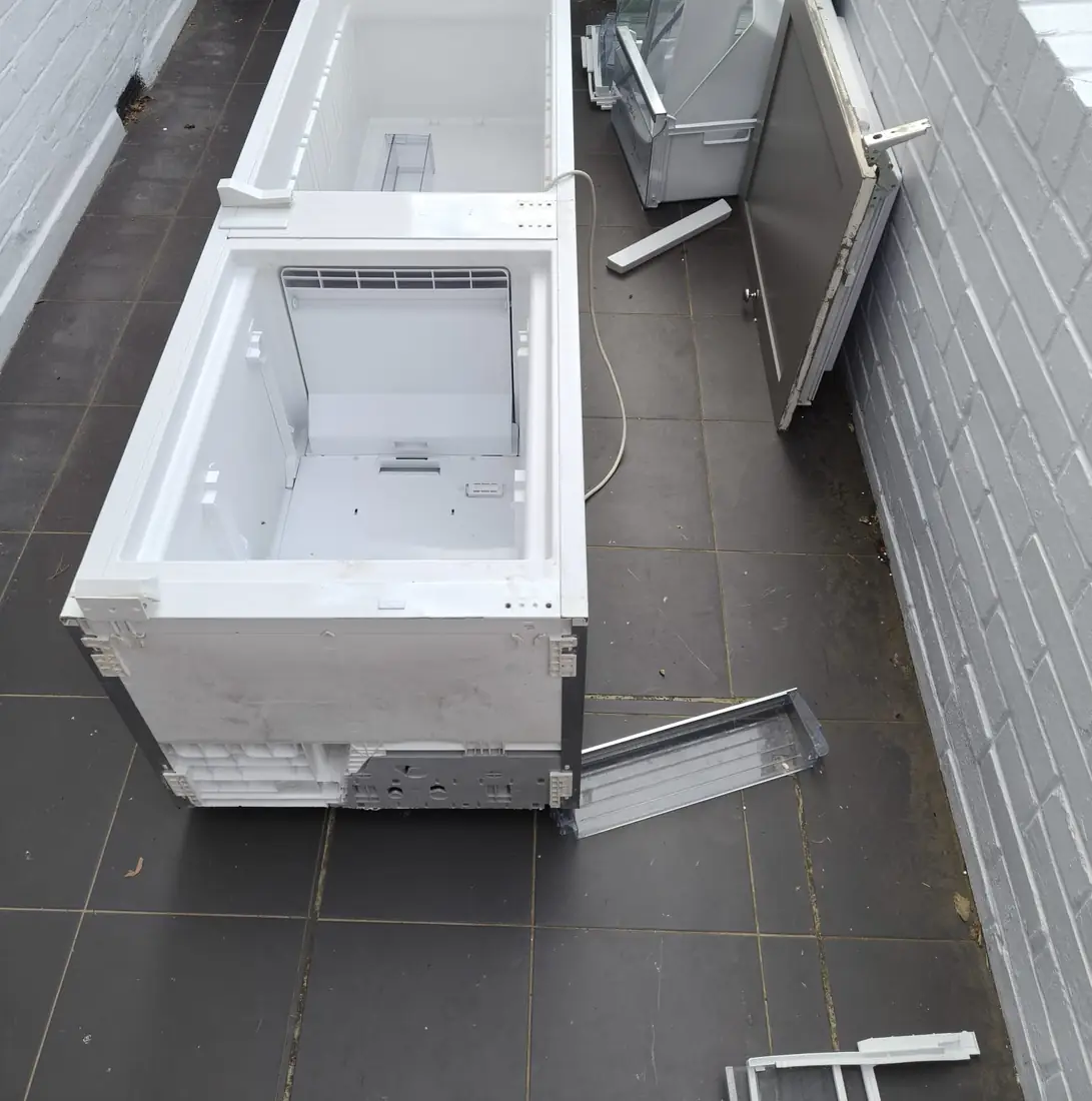 Integrated fridge freezer dismantled and ready for removal