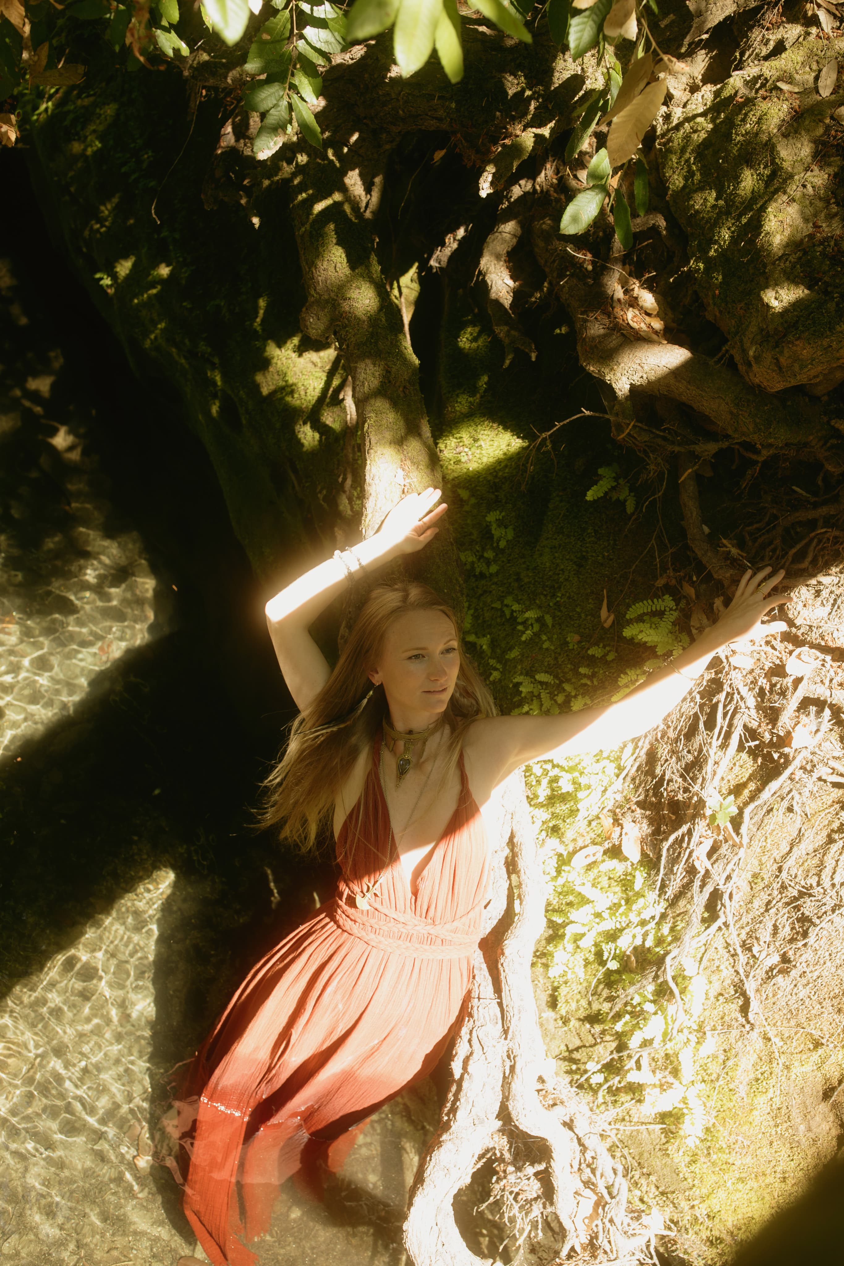 Woman in red dress in nature during plant medicine ceremony