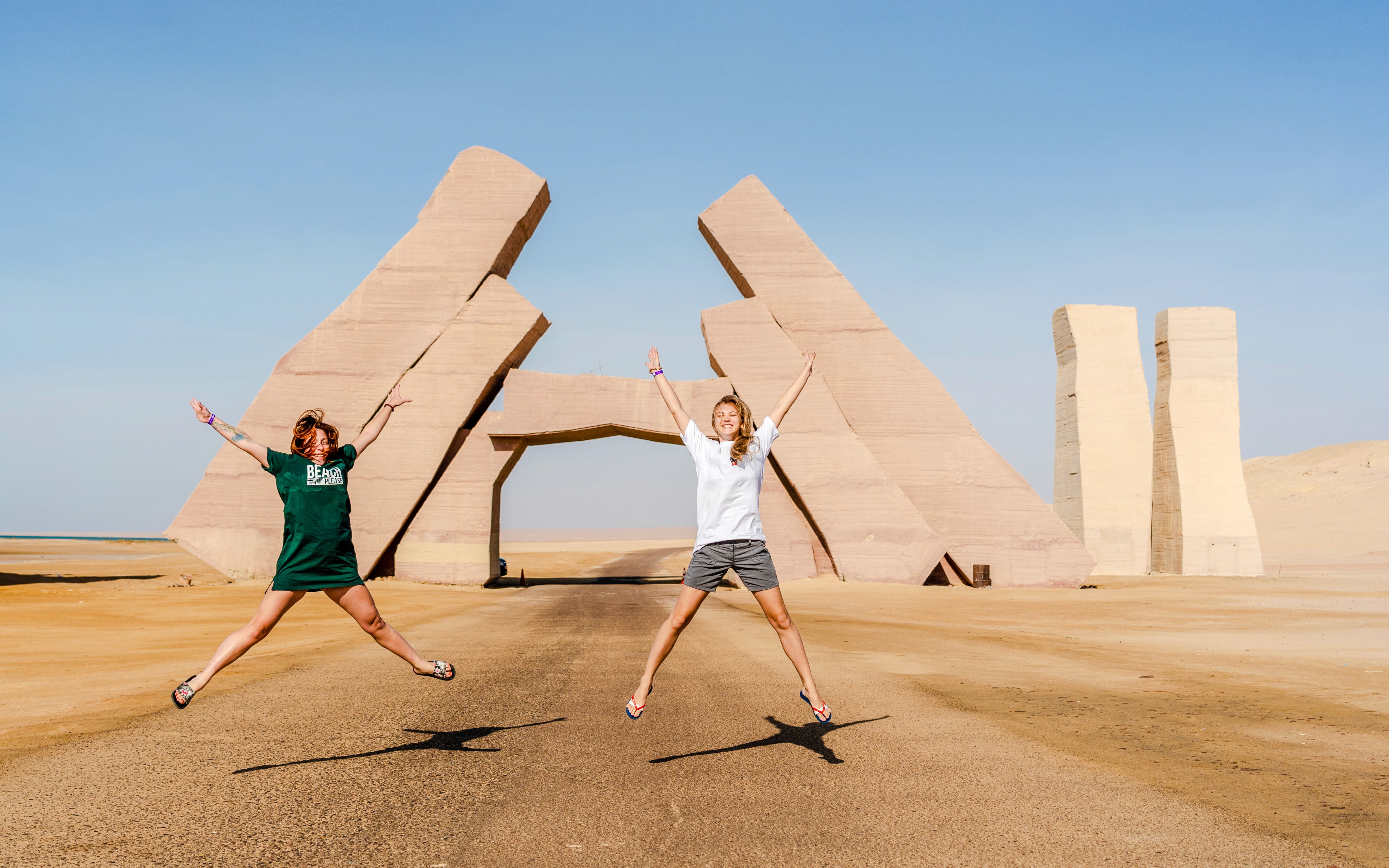Girls jumping near the Gate of Allah in Ras Mohammed National Park, Egypt.