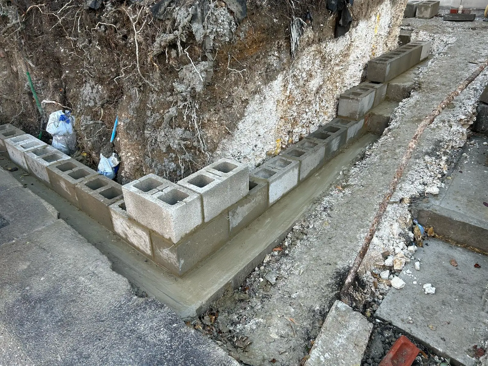 An aerial view of a rocky terrain with a stone structure and pathways visible along the landscape.