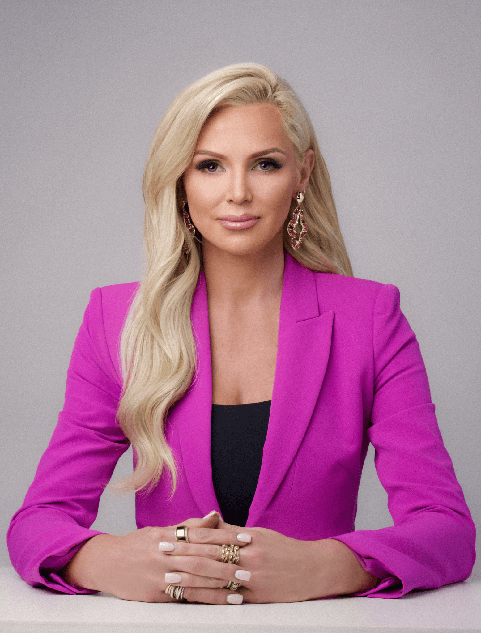 Bethany Schneider wearing a magenta blazer in a professional studio portrait.