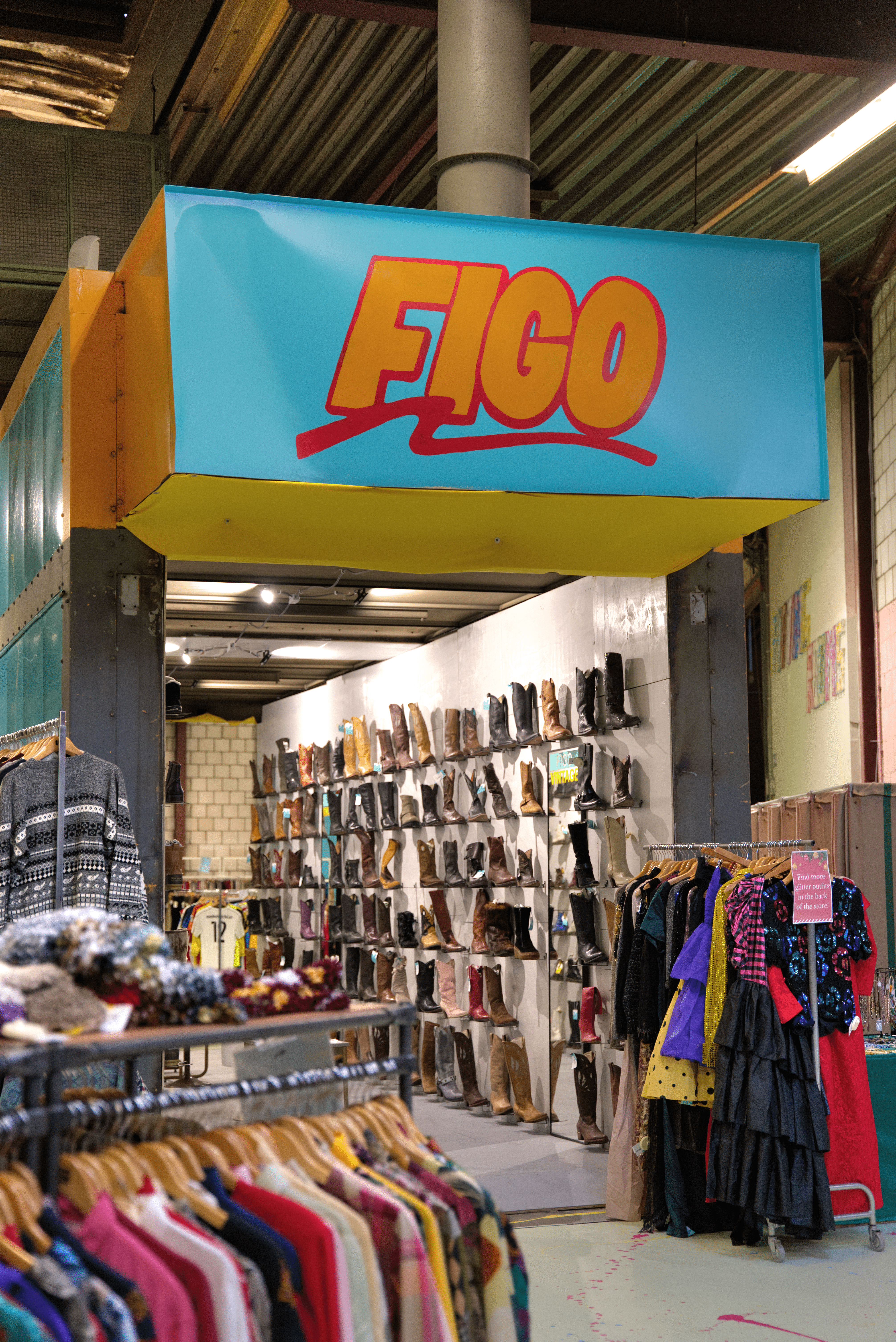 Figo vintage store entrance with hanging clothes and wall of boots.