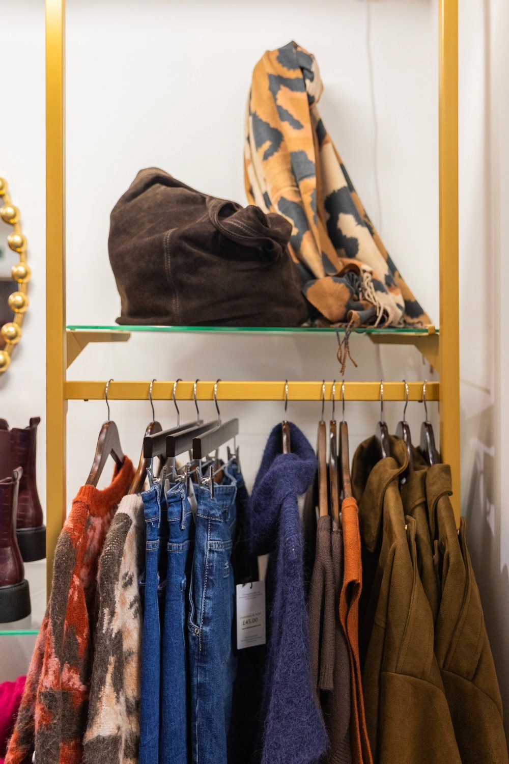 Close up shot of clothes on hangers in retail setting.