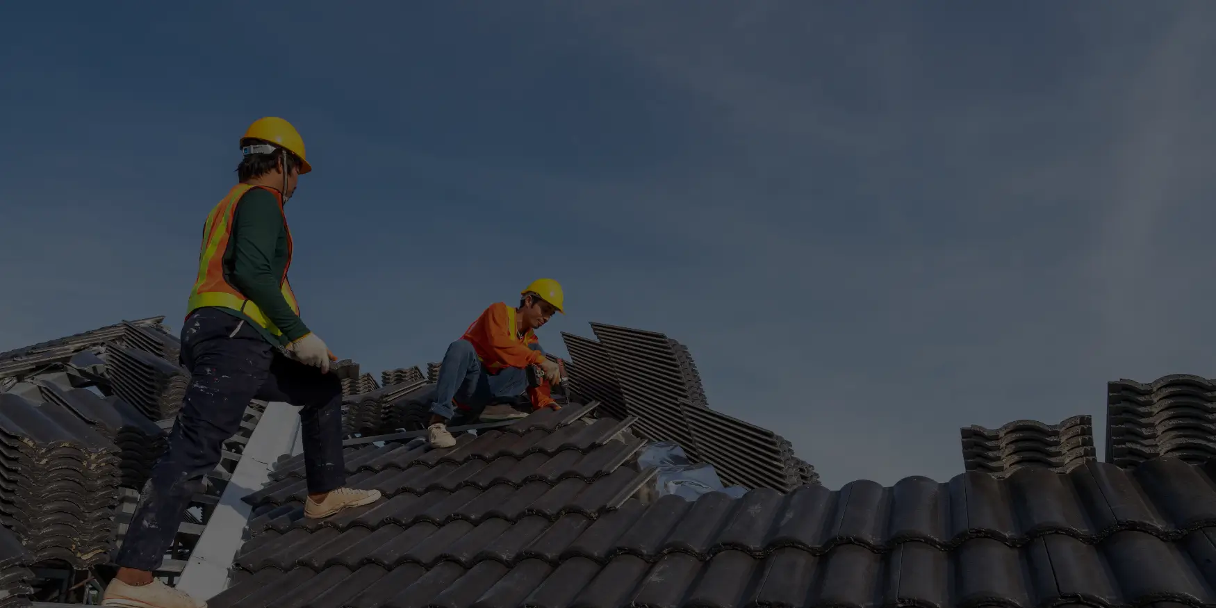 Roofing contractor installing shingles on residential roof