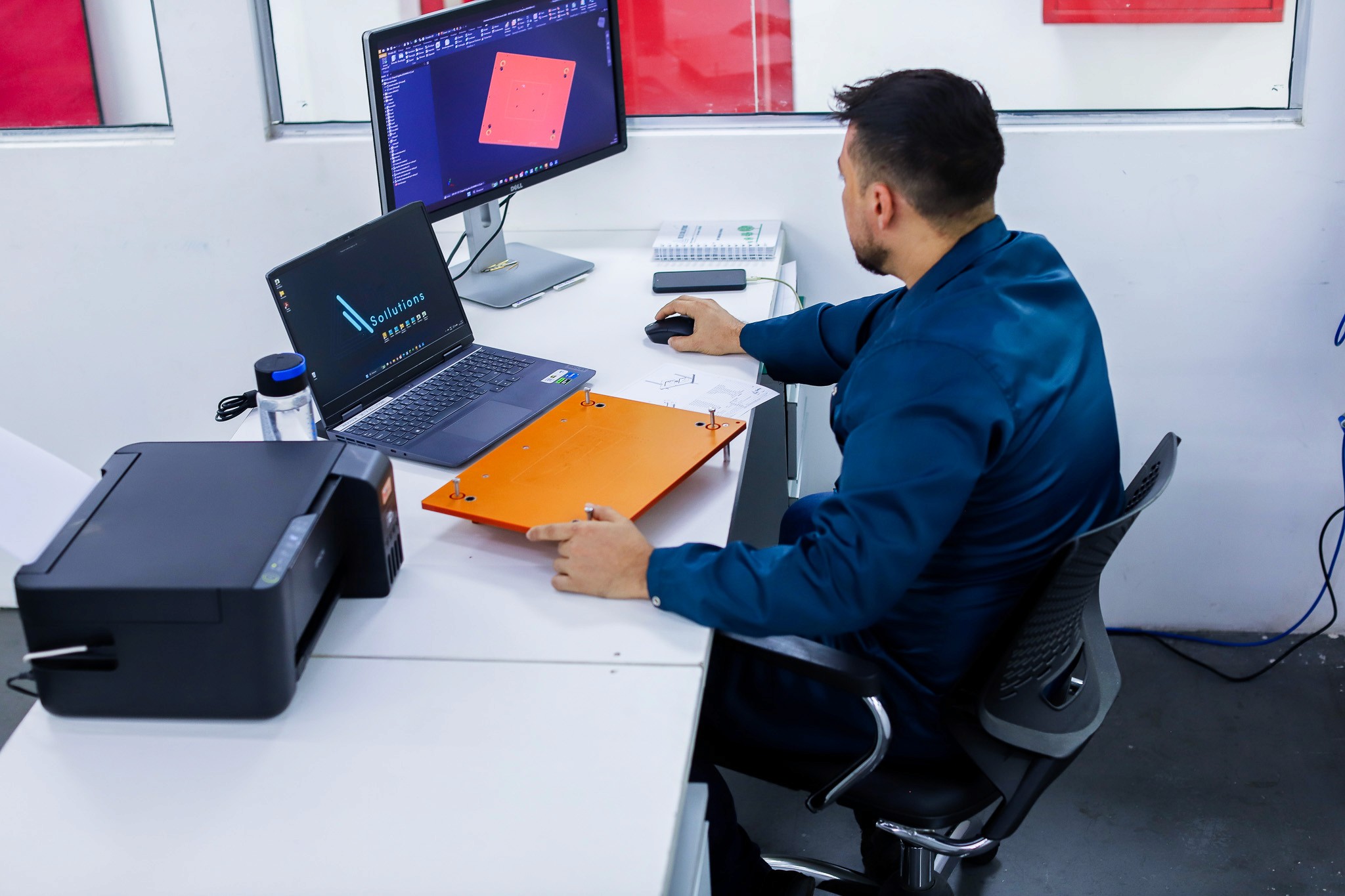 A woman in a straw hat stands in the grass
