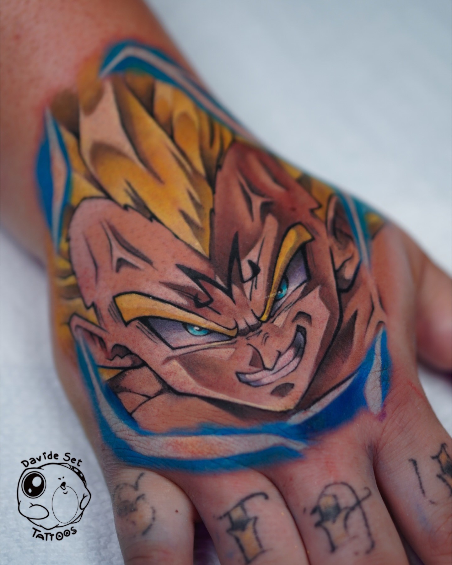 colorful anime tattoo of majin vegeta on a hand