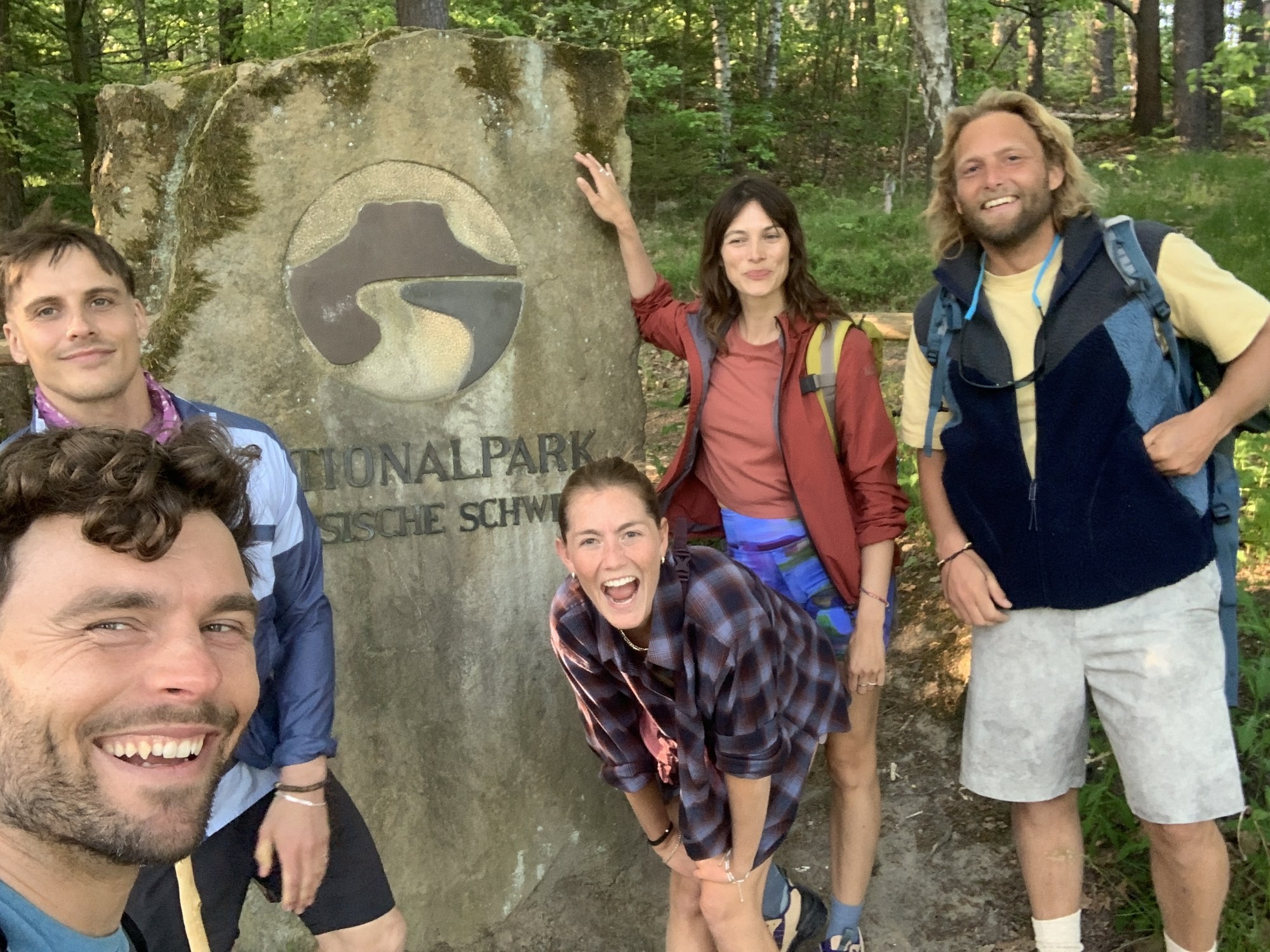 Five cast members of the Radeberger commercial at the Saxon Switzerland National Park marker stone