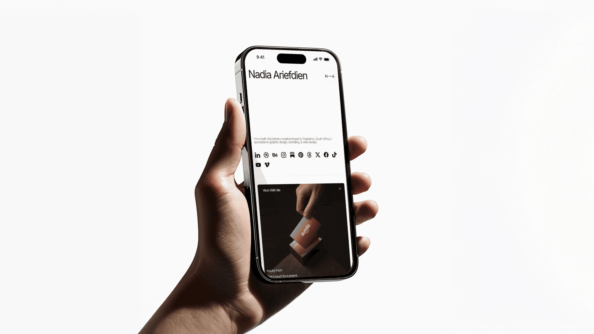 A person's hand holding an iPhone. The screen shows Nadia Ariefdien's link in bio website.