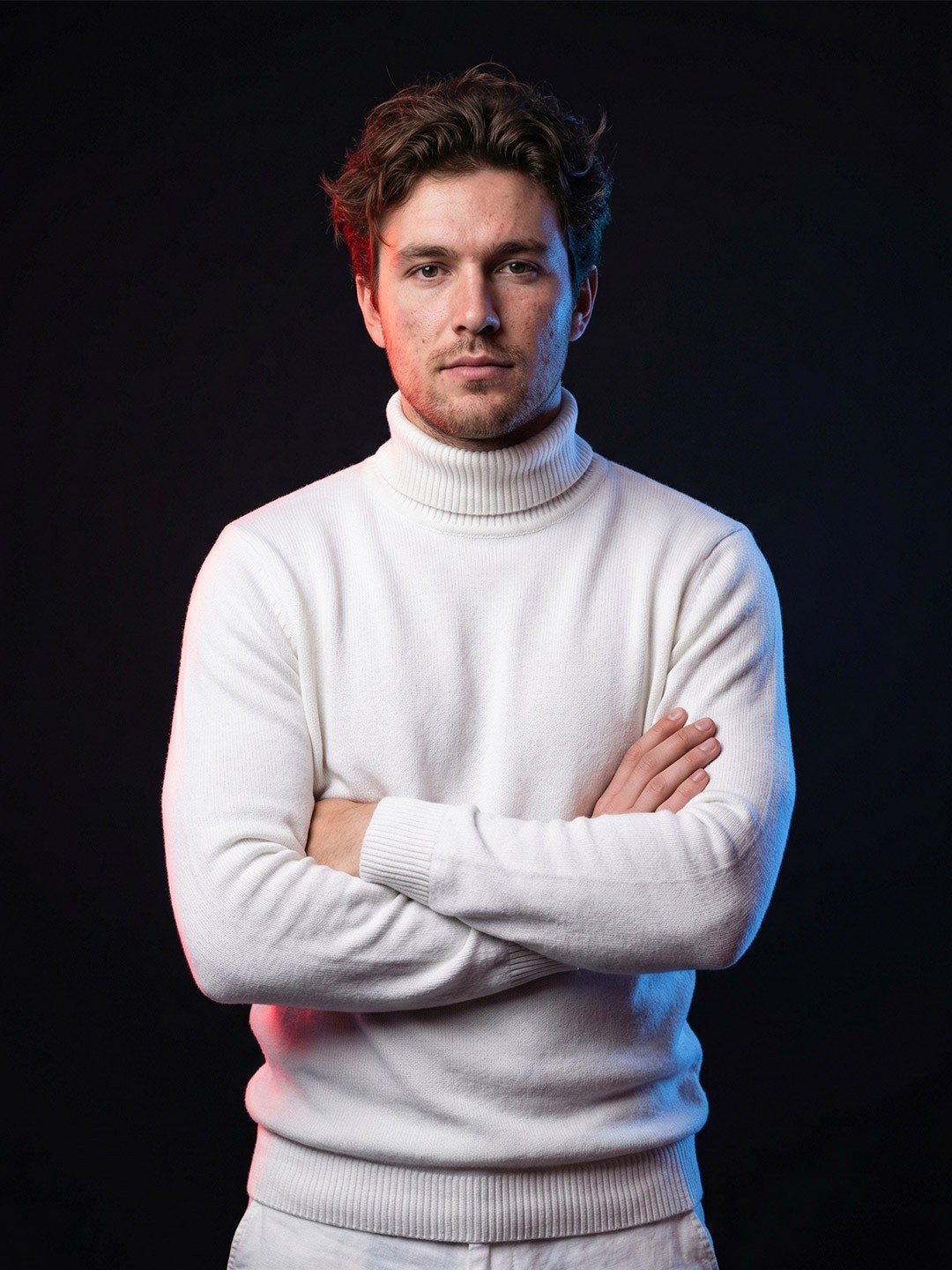 Portrait of a person in dark clothing speaking on a phone