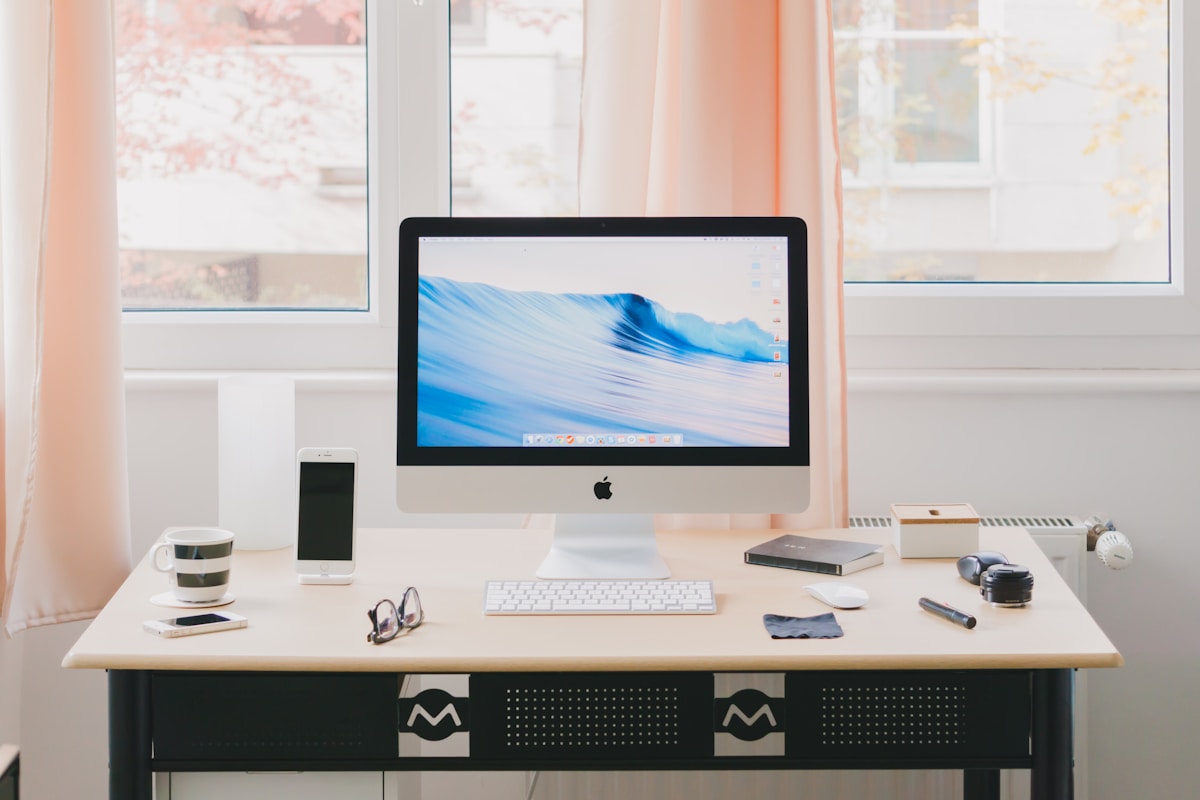 Apple iMac computer and accessories on a desk, ready for work or study.