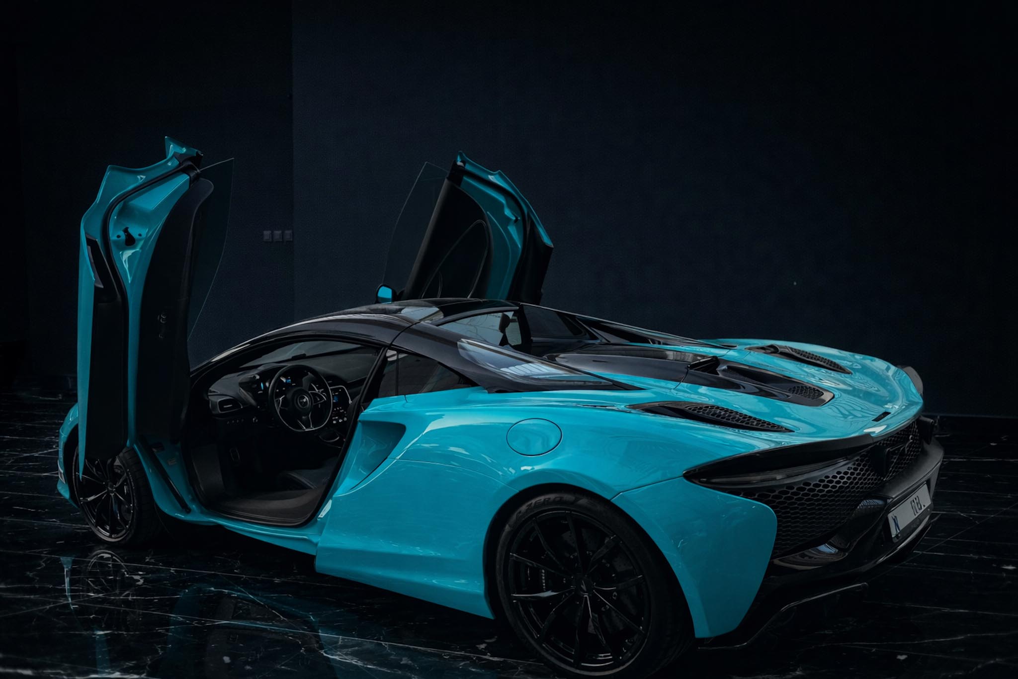 McLaren Artura Spider 2025 Cerulean Blue exterior rear side by Queen of Supercar Rental Dubai
