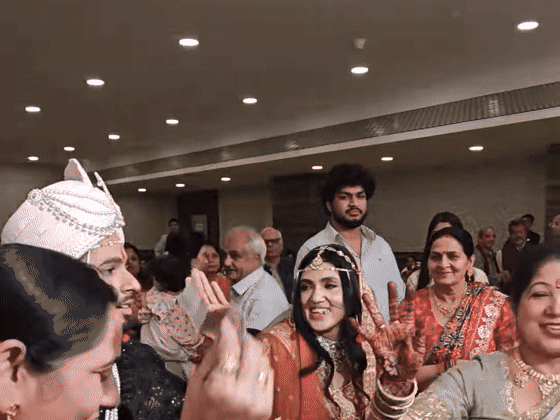 Sarika dances through the wedding procession amid family and friends