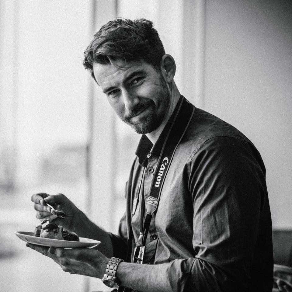 Abstract art of two faceless figures in red and black against a yellow background.