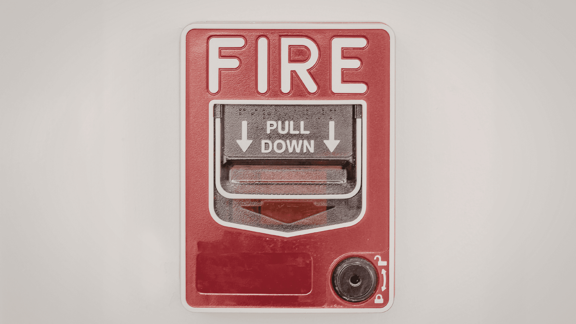 A red fire alarm on the wall.