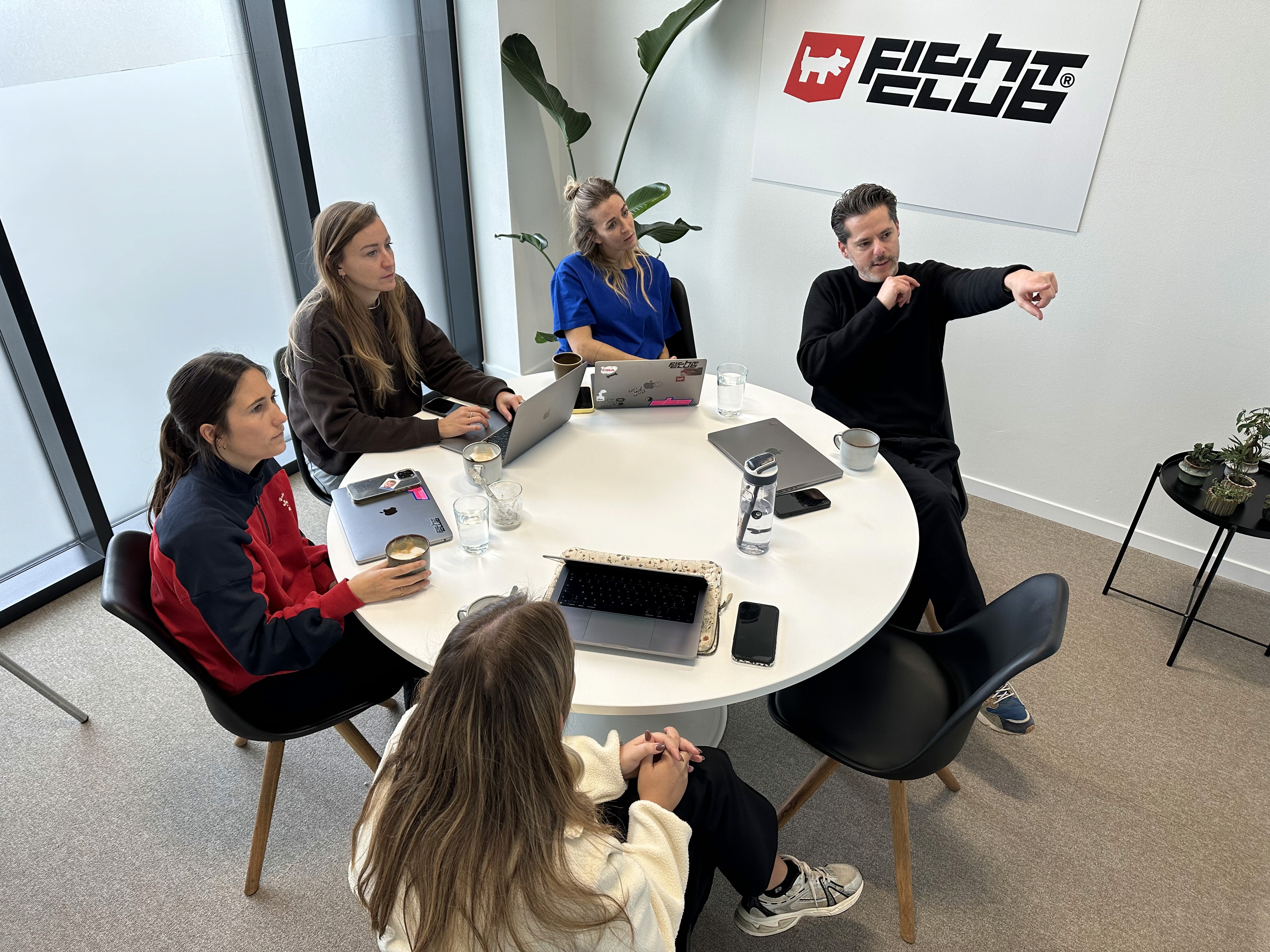 a woman sits at her desk looking at a purple wallpaper