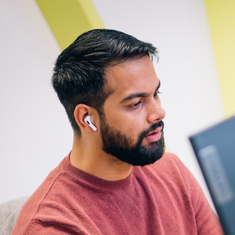 Photo of an Opencast team member working at a computer