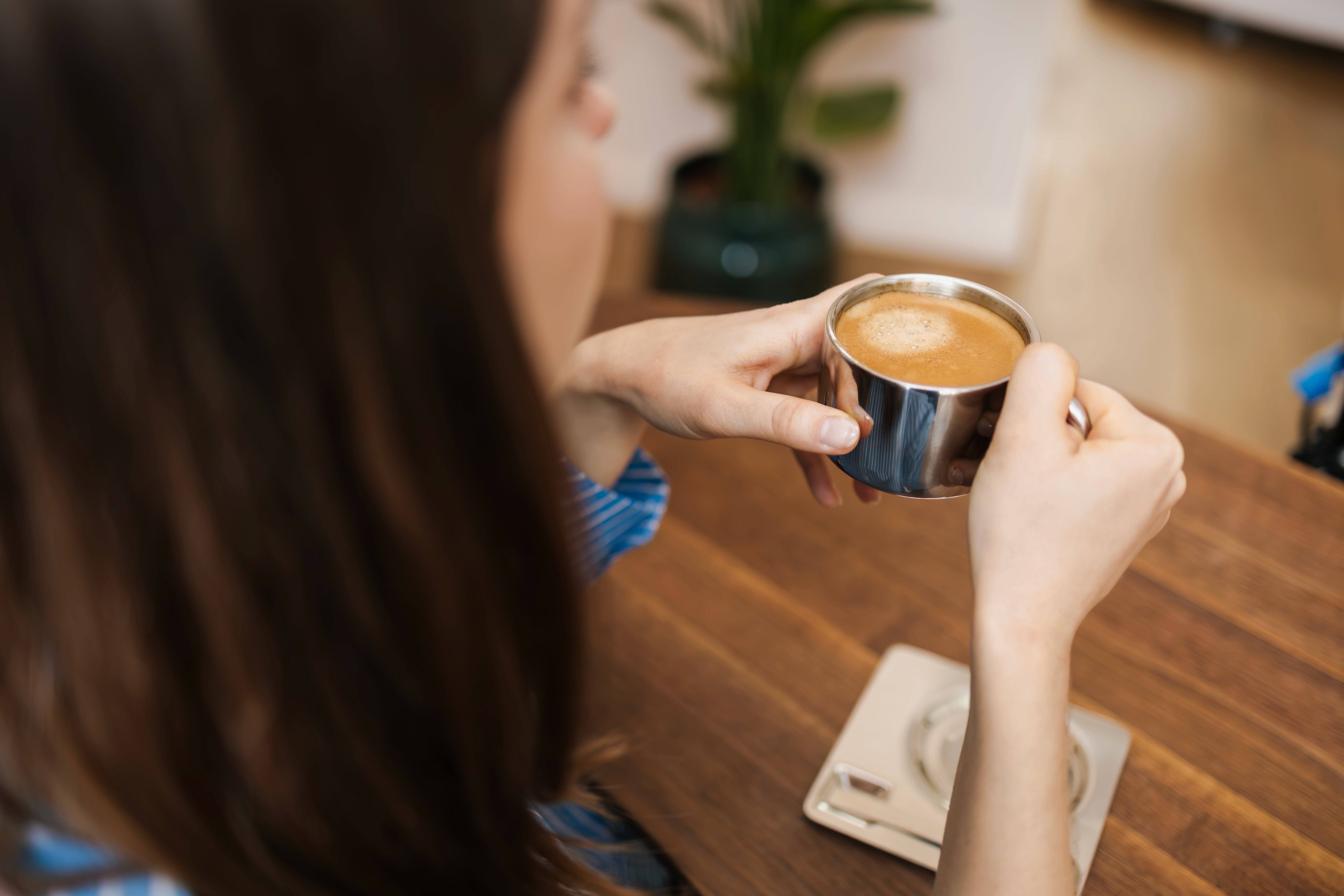 Dr. Louise Cuveele having holding a cup of coffee.