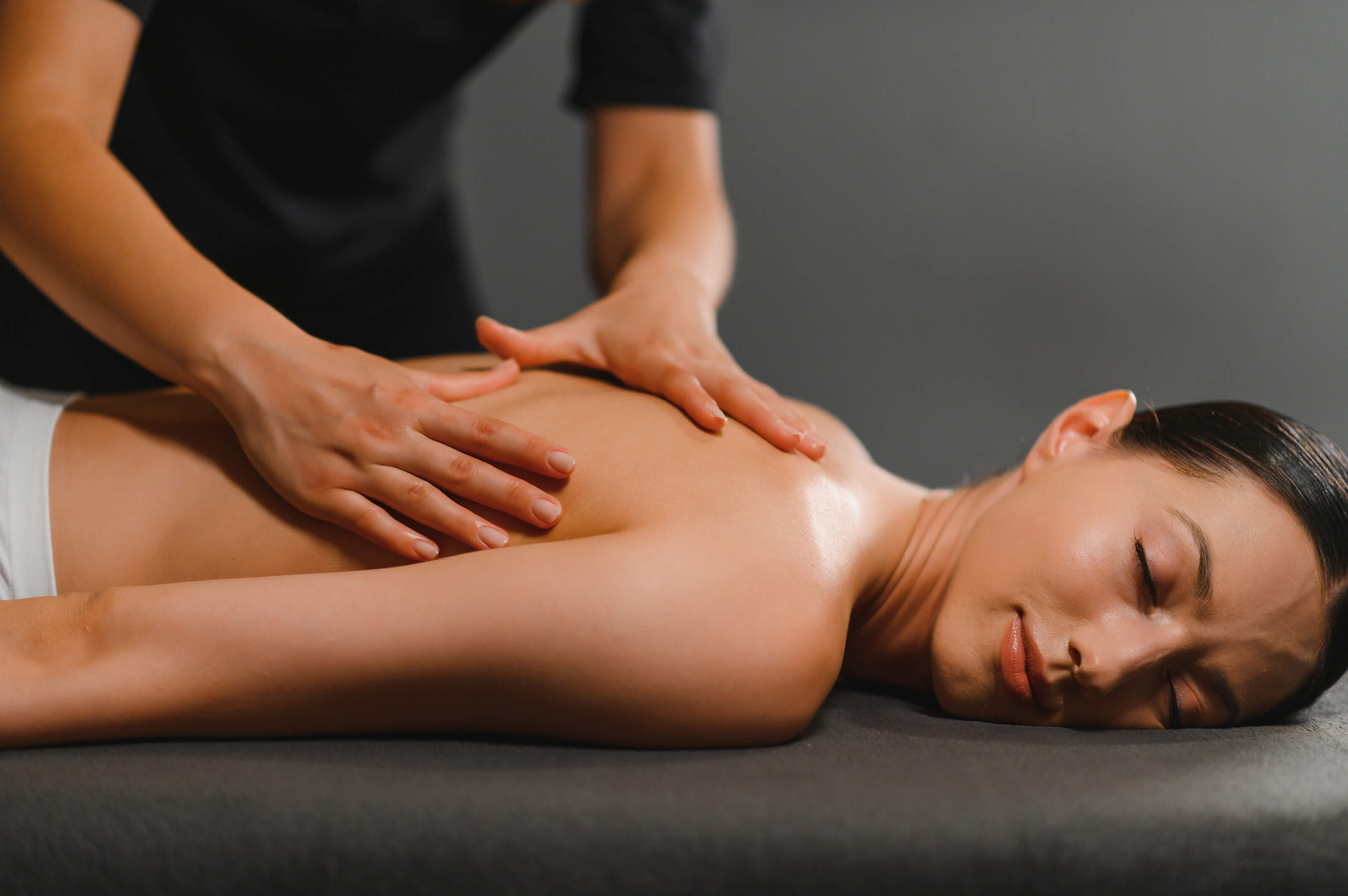 Woman receiving upper-back massage