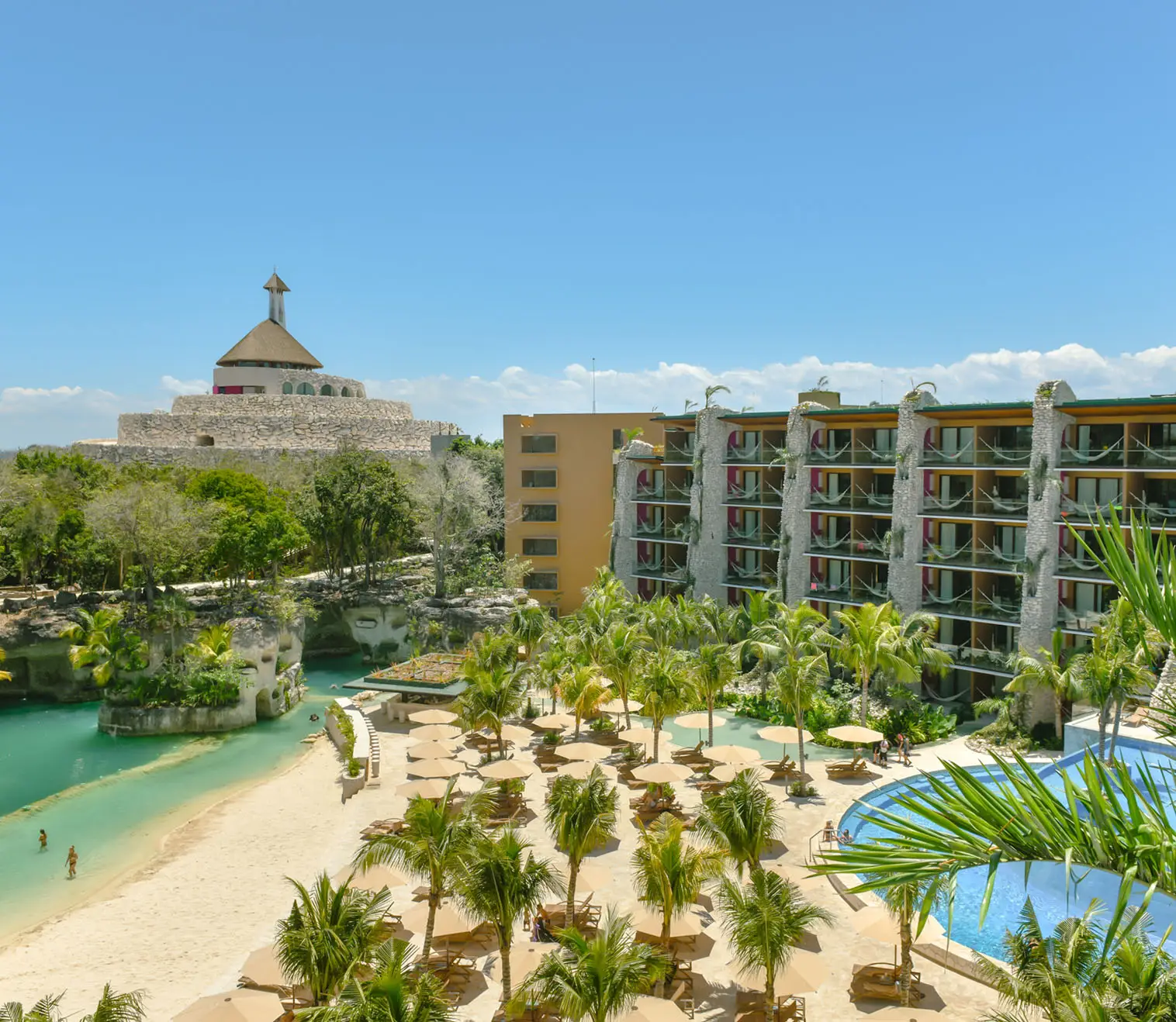 green and brown mountains near body of water under white clouds and blue sky during daytime