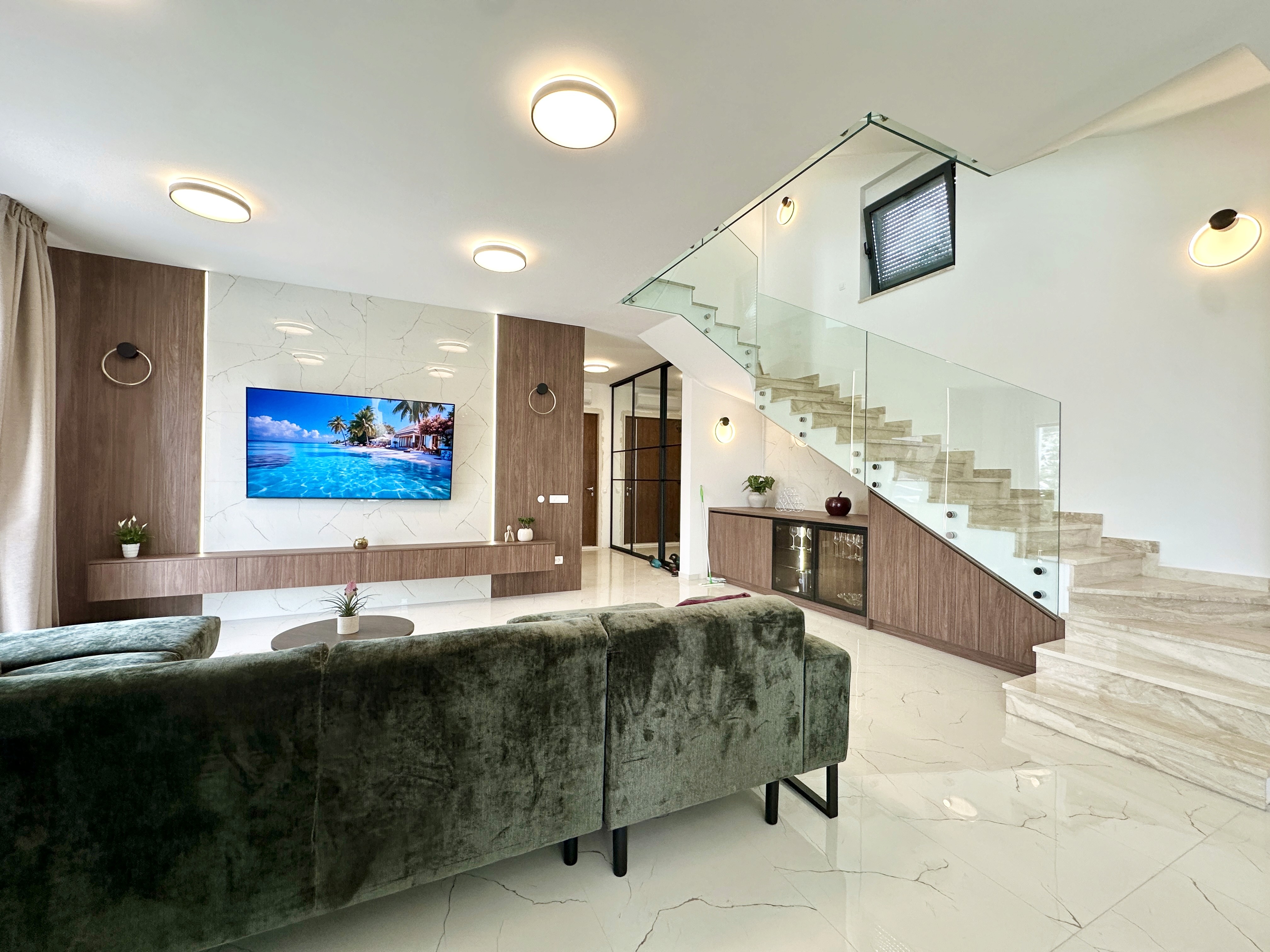 Bedroom with wall bookshelf and mountain view.